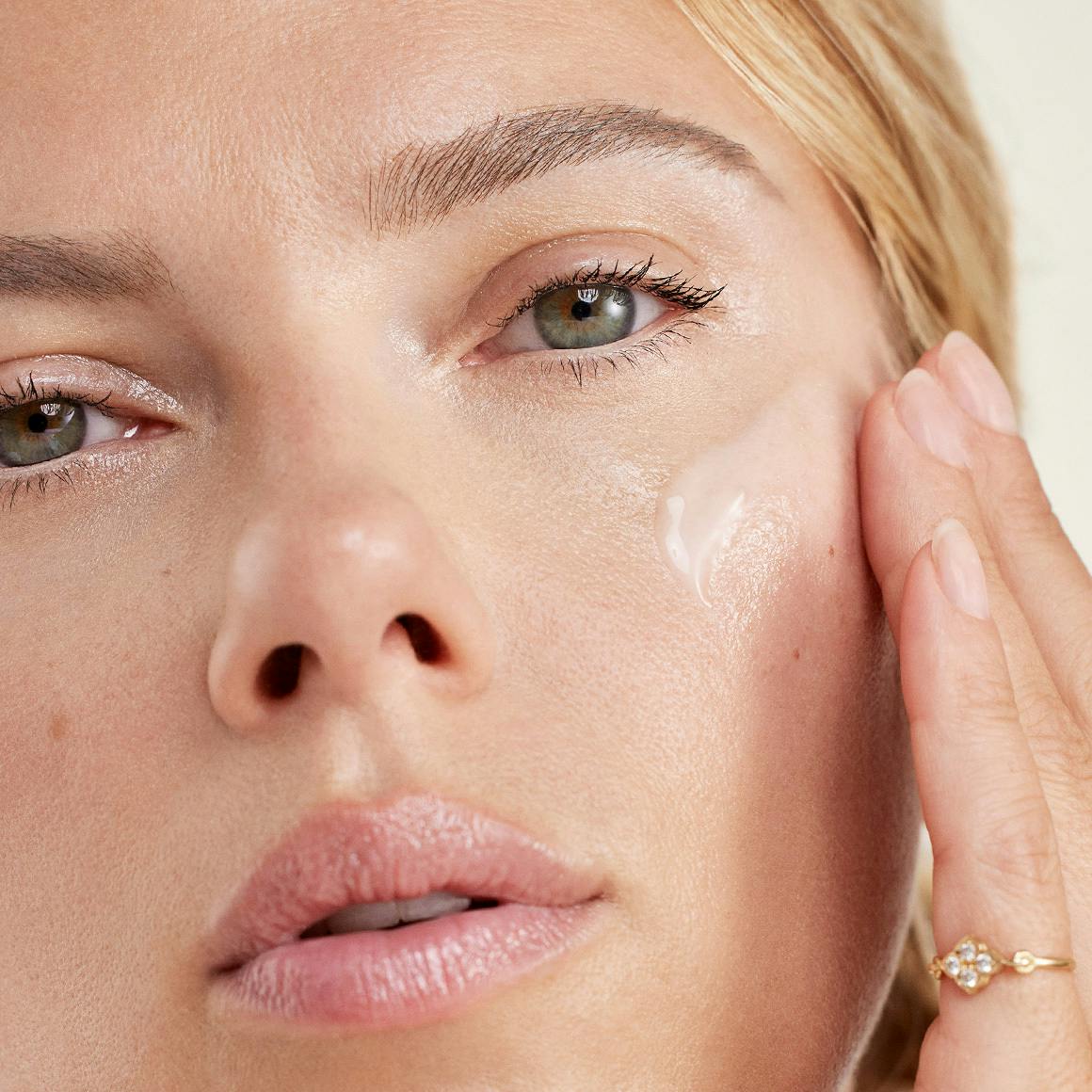 Photo of Scarlett Johansson applying with The Outset's prep serum to her face