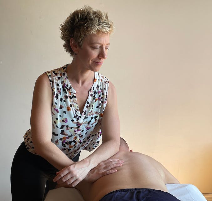 Jennifer Lyons' massaging the back of a male