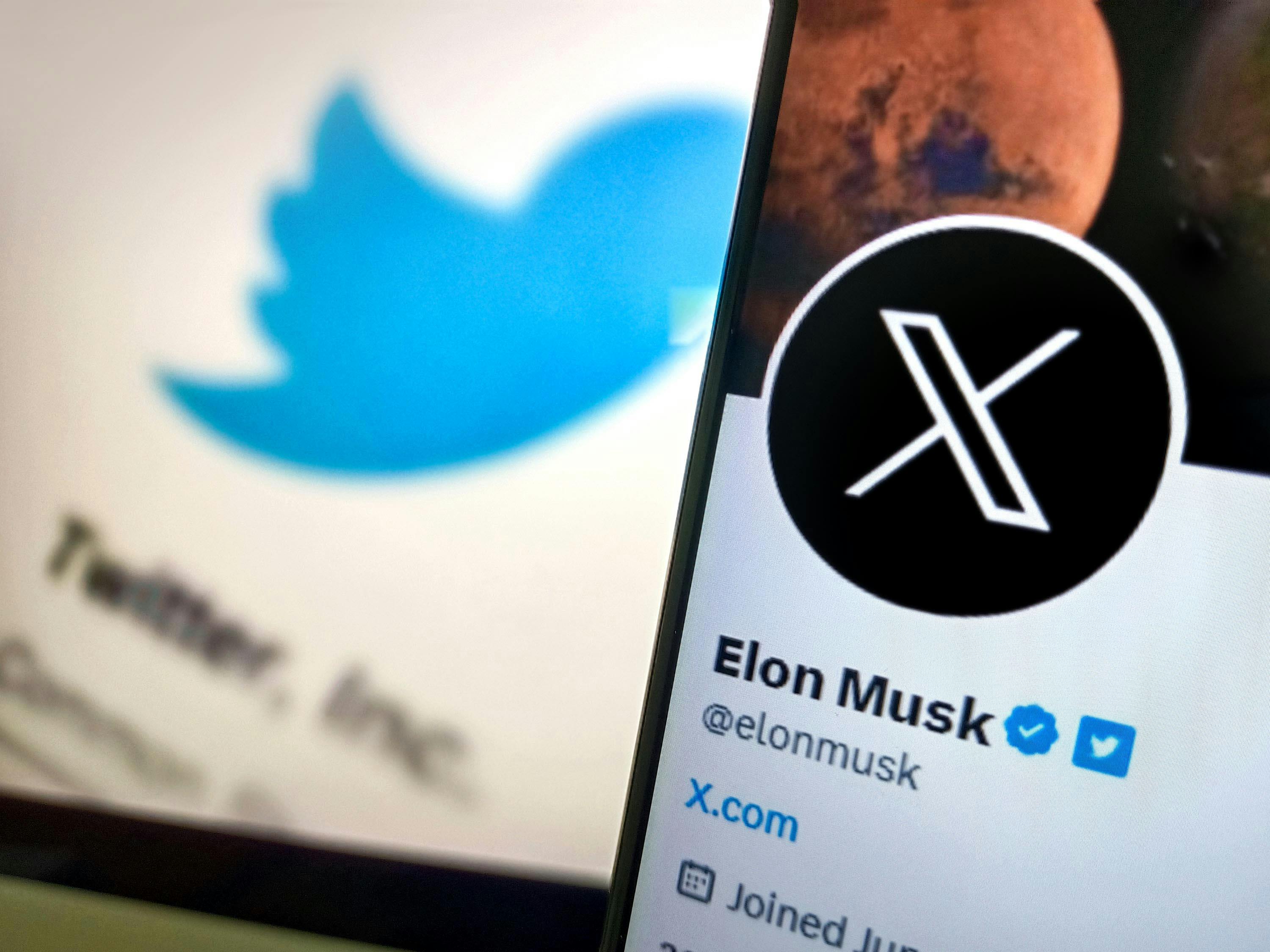 Elon Musk next to Twitter's new X Rebrand