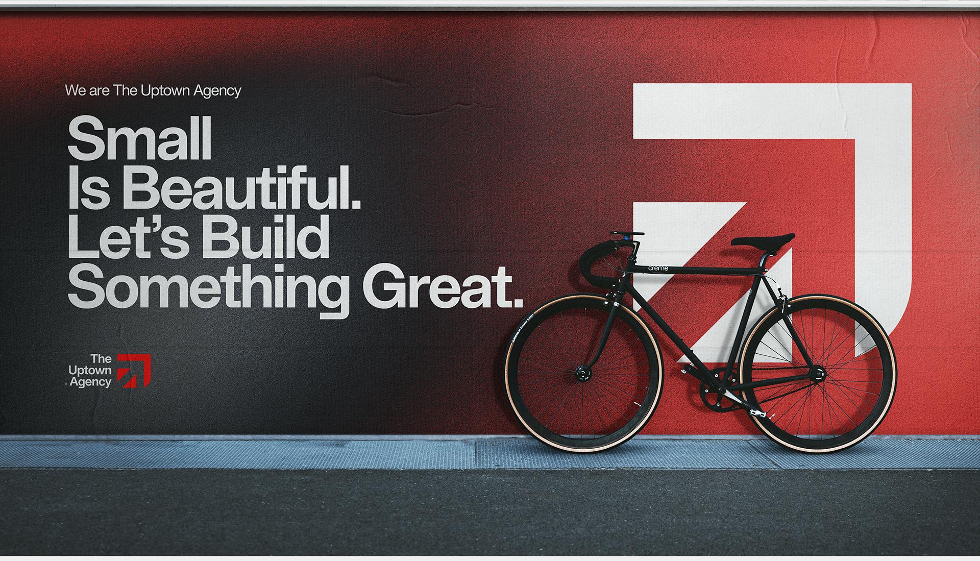 The Uptown Agency Logo on a wallscape with a bicycle in front