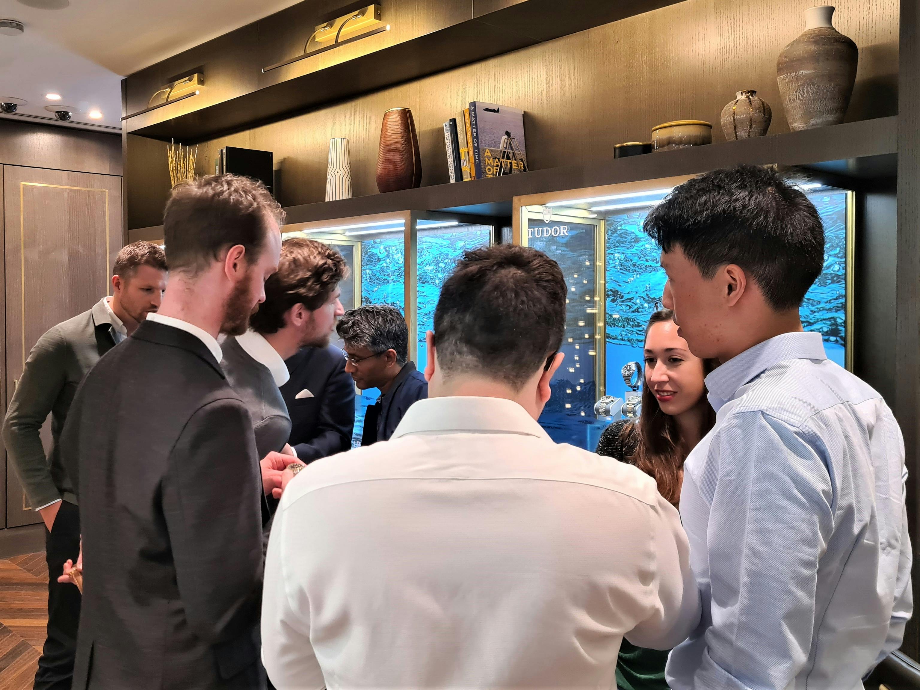 People looking at watches and watch cases at our recent event with a Retail Partner