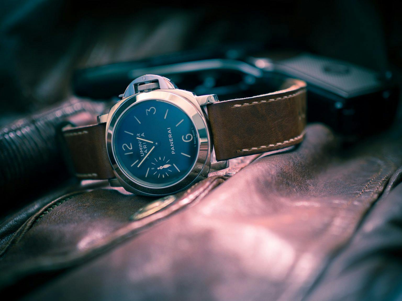 Steel Panerai Dive watch with black dial large hands and numerals and a brown leather strap