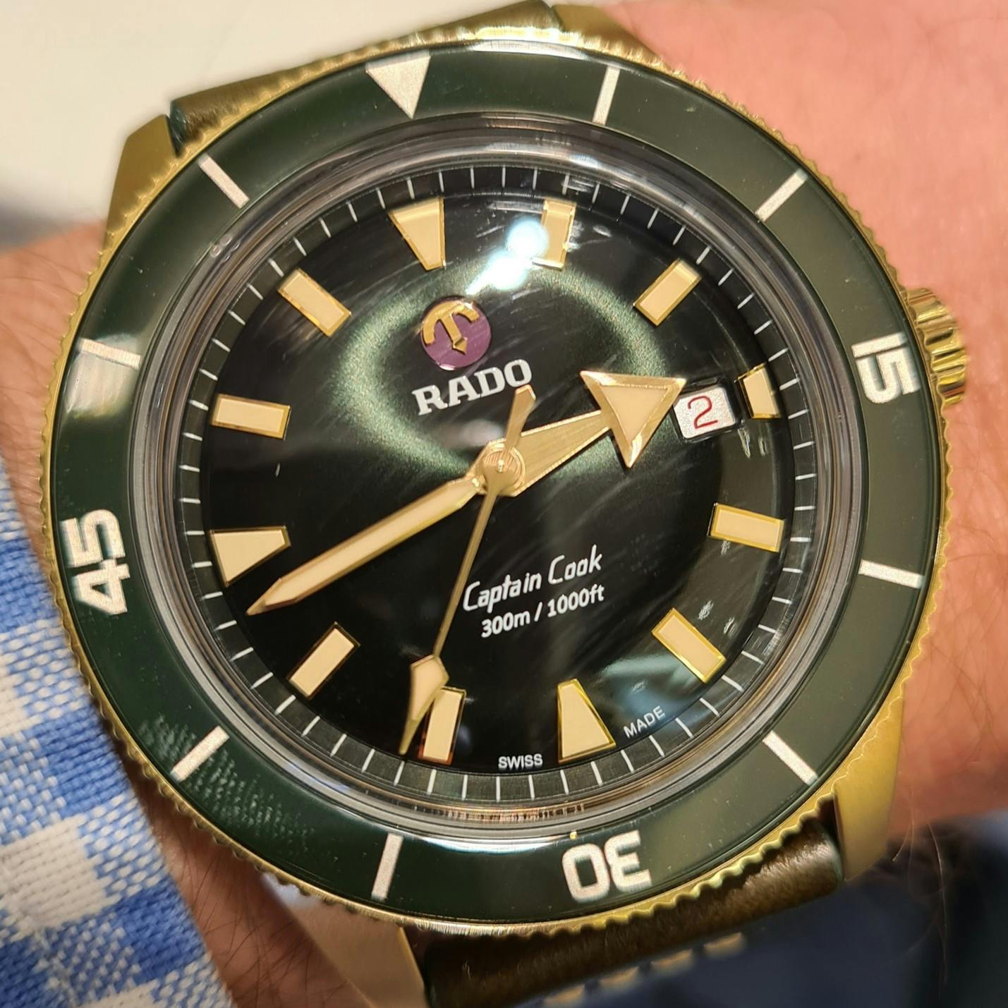 The Rado Captain Cook, which is an example of many current design trends in the watch world; that of Green watches with green bezels (the turning part around the outside) the re-issuance of a historic model, as the Captain Cook was first launched in 1962. This model is available in three different cases; steel, bronze and ceramic, following the trend for more case variety across watch ranges.