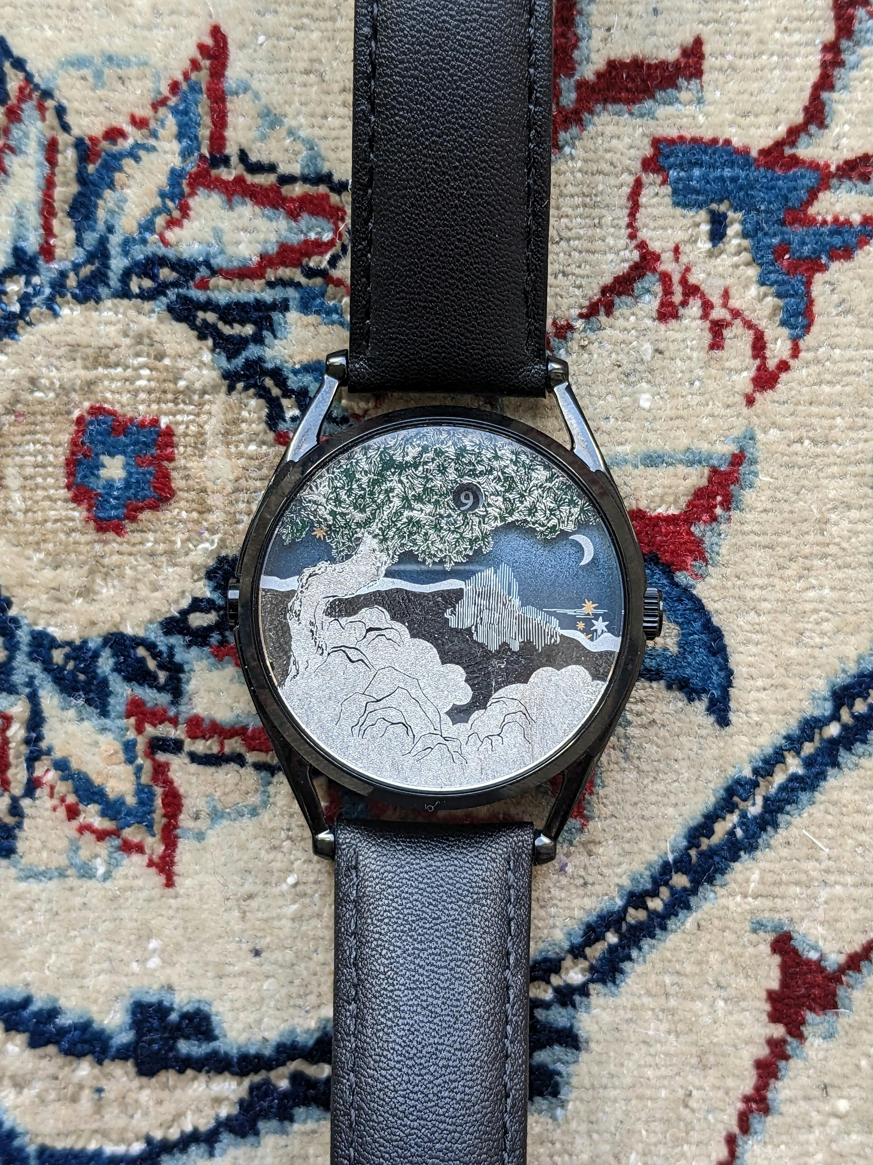 The Ascendant watch from Mr. Jones Watches. The jump hour is in a small window in the tree branch, and the minutes are read depending on the number of stars passing the 3 O'Clock position. This design is created using palladium plating on the underside of the crystal, which is highly unusual.
