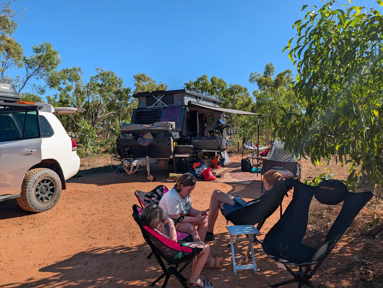 The children reading while we packed the caravan. The reading part is great. The refusal to help in the pack up is less appealing....