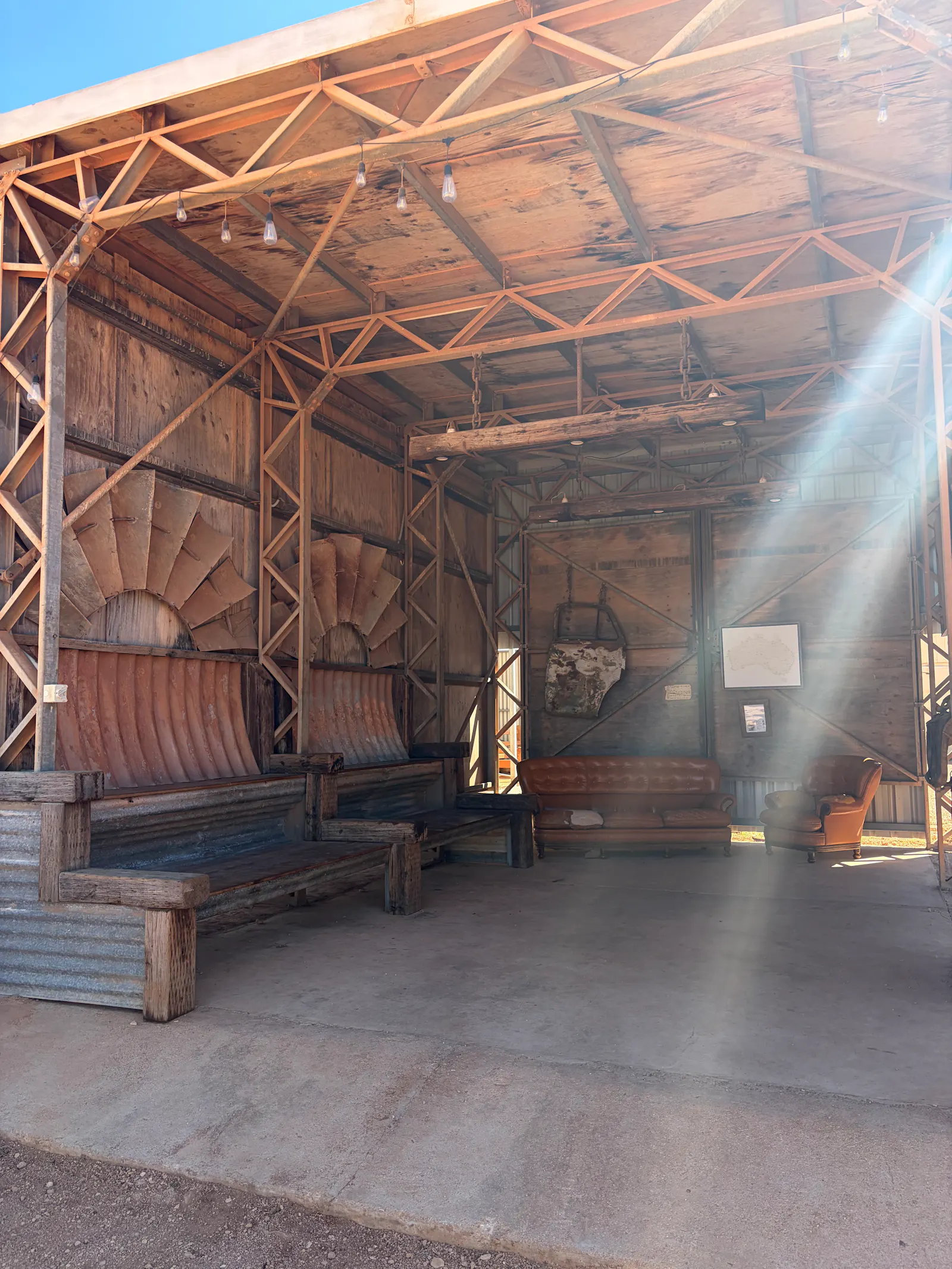 An old shed that had been converted to a viewing room with tiered seating and a wide screen tv.
