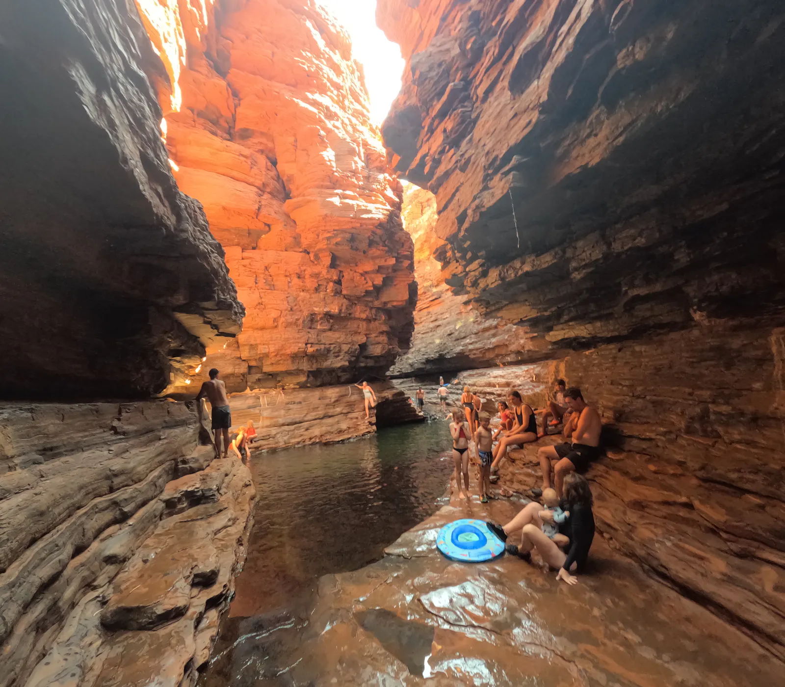 The narrow passageway opened up to a glorious pool surrounded by gorgeous red rippling rock walls. 