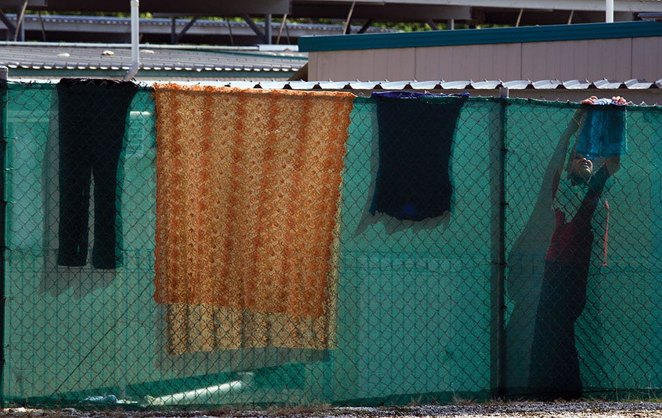  An Iranian detainee hangs up her laundry on the fence at the Construction camp detention center used for younger men and women and children. February 26, 2012, on Christmas Island, Australia. Photo: Paula Bronstein / Getty Images 