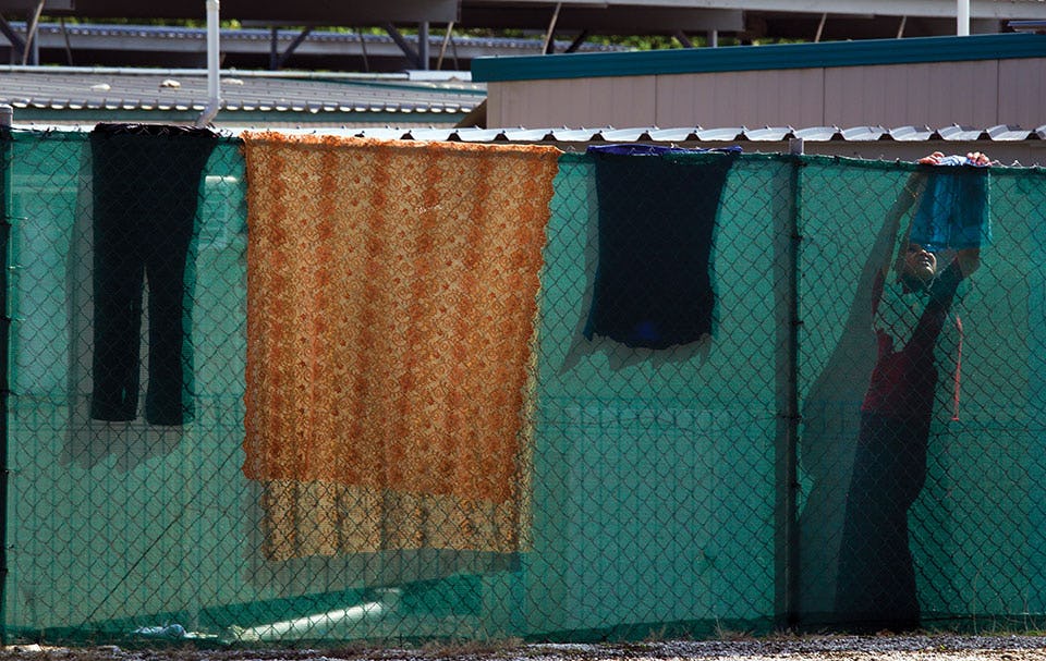 An Iranian detainee hangs up her laundry on the fence at the Construction camp detention center used for younger men and women and children. February 26, 2012, on Christmas Island, Australia. Photo: Paula Bronstein / Getty Images