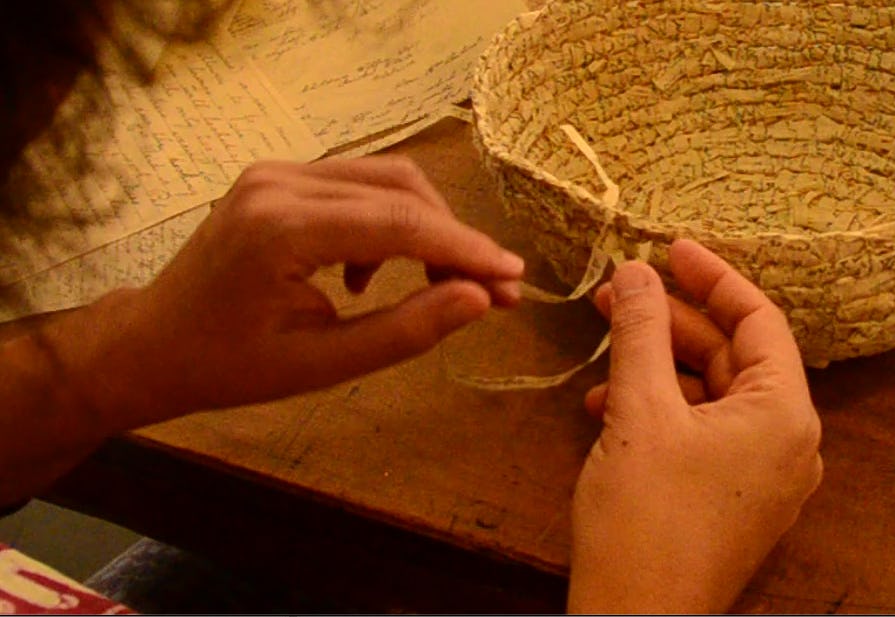 Image of someone weaving a basket from letters from the State's Aborigines Protection Board and Children's Welfare Board files