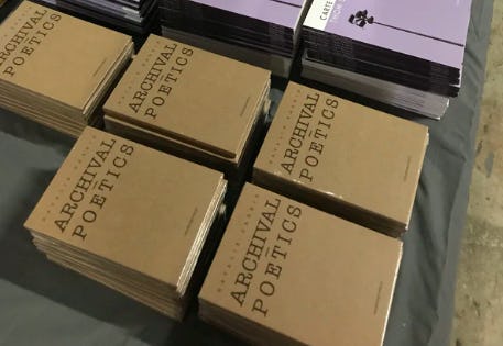 Photo of stacked copies of Archival-Poetics by Natalie Harkin. Photo from Vagabond Press website.