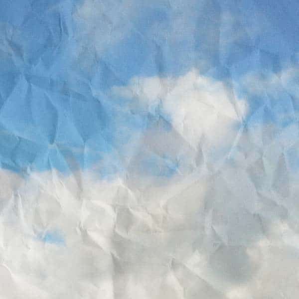 An image of a crumpled piece of paper portraying clouds and a blue sky (no credit provided)