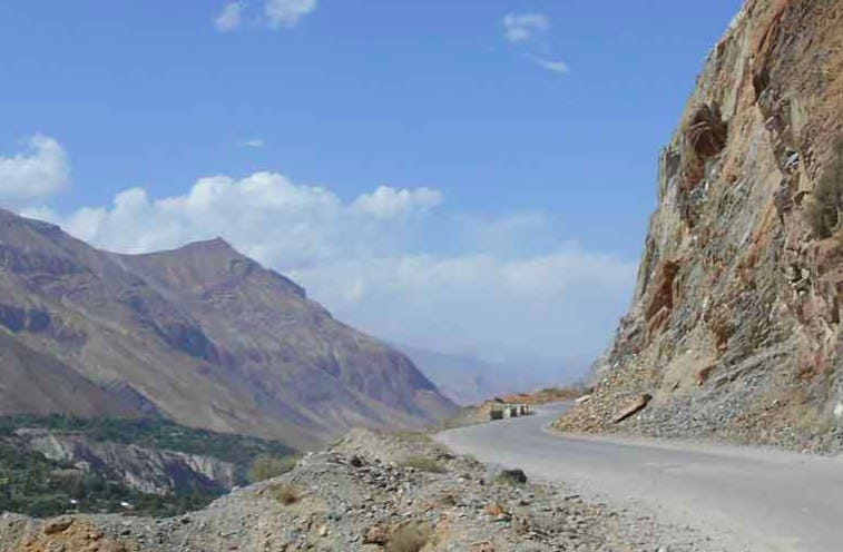 A photo of a road cut into the side of a mountain. Photograph by Umair Mushtaq