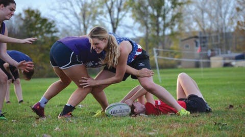 Kenyon student rugby players grapple over the ball