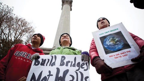 Protestors hold signs in the Mount Vernon town square