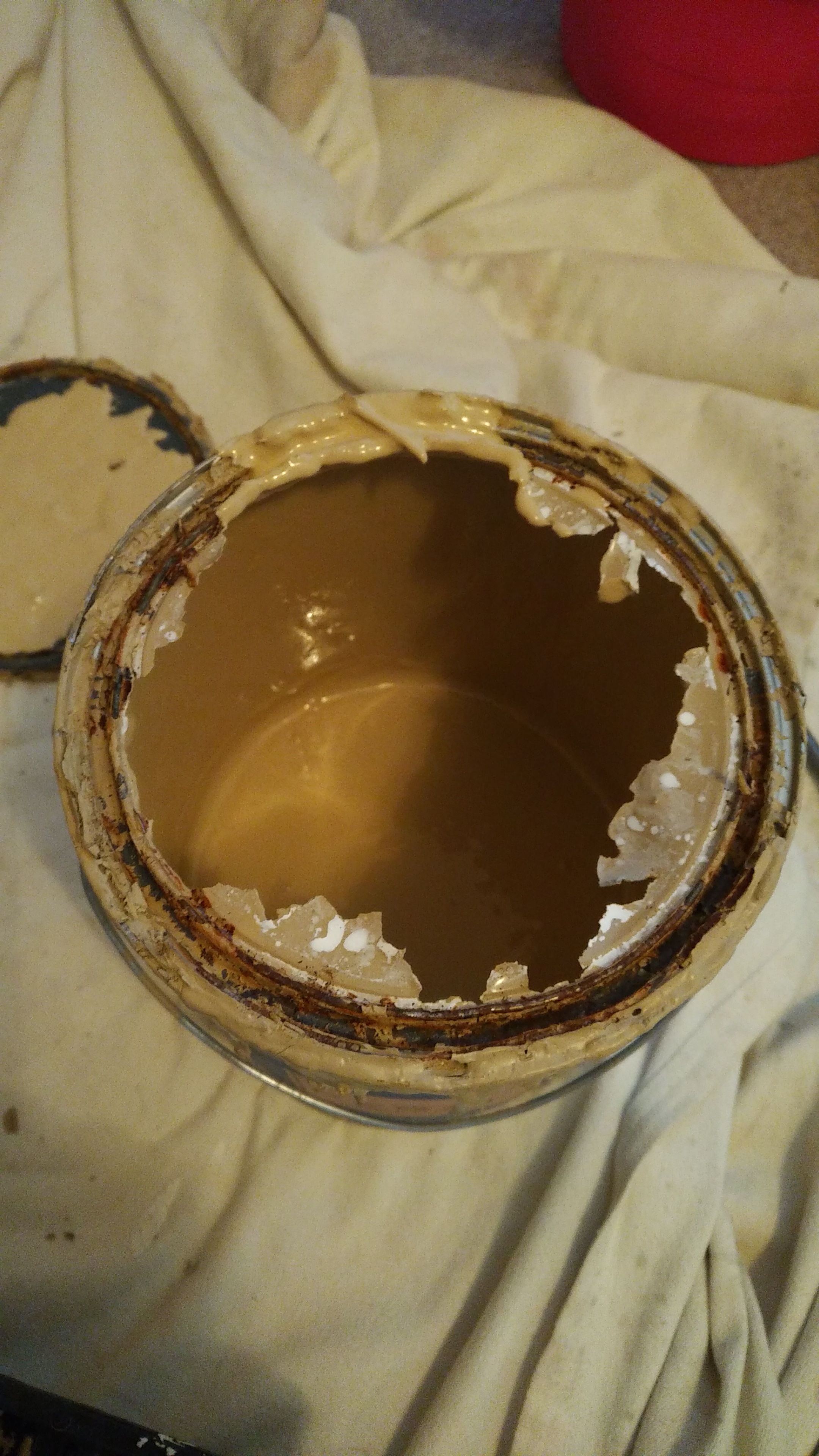 Open Paint can with dried paint