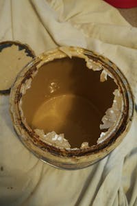 Open Paint can with dried paint