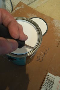 Full can of white paint and screwdriver