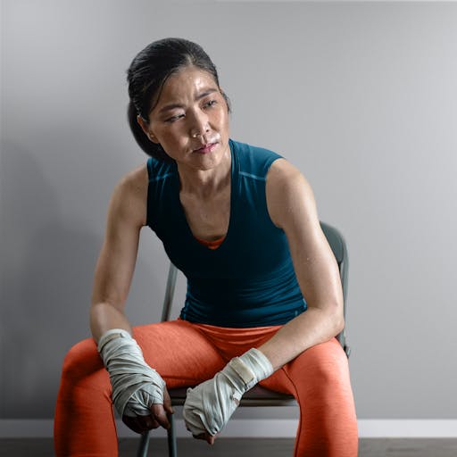 A portrait of a person sitting on a chair after a workout