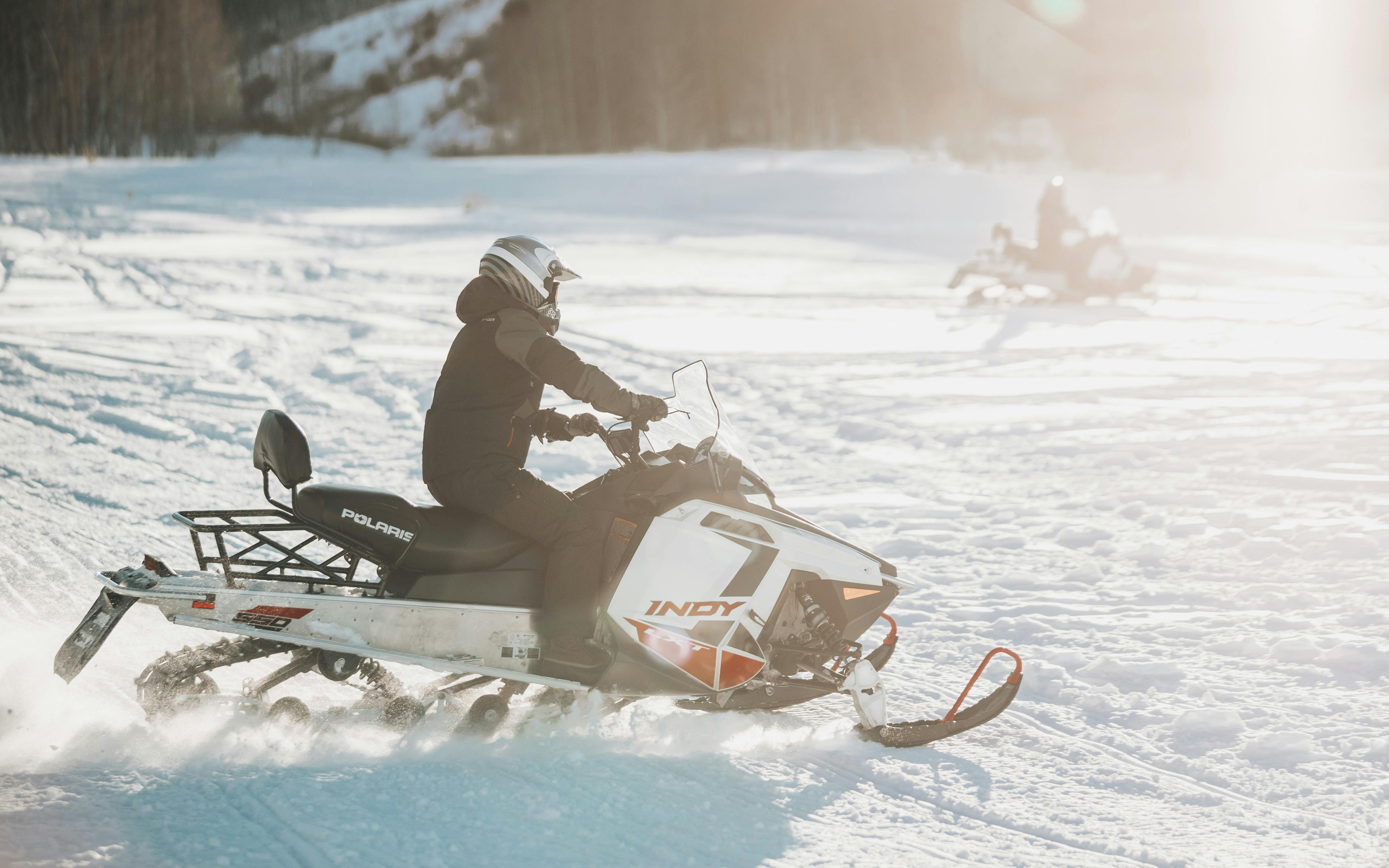 A man riding a snowmobile