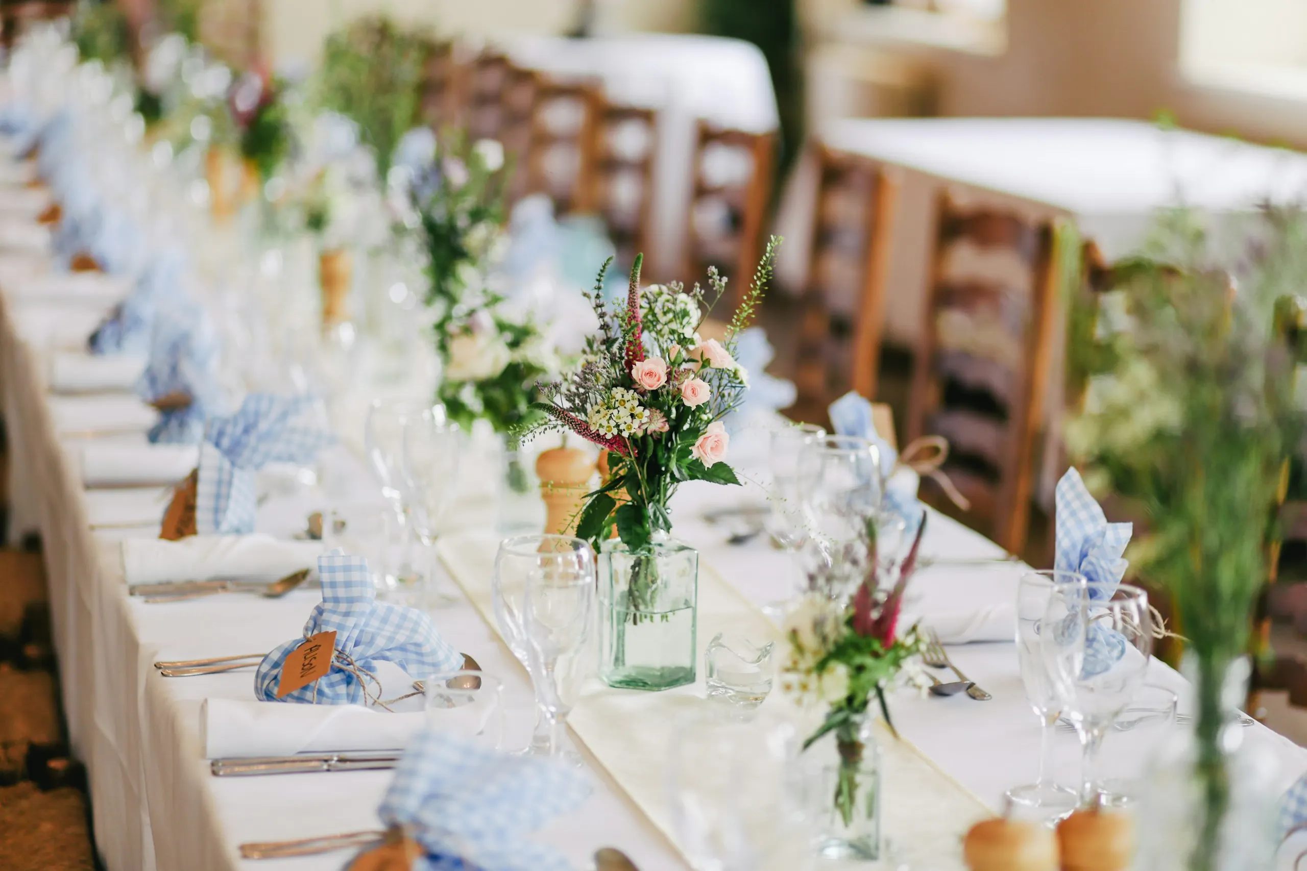 A wedding reception table set with flowers and candles