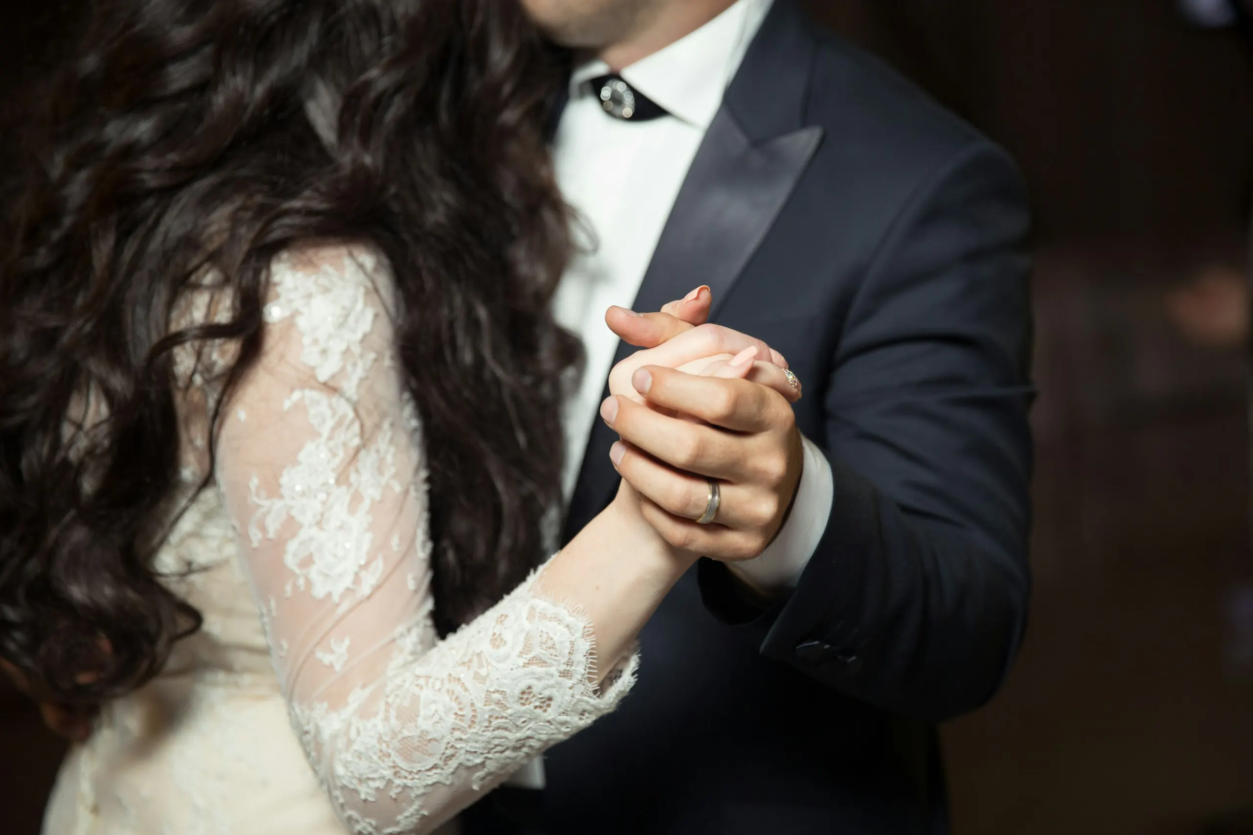 A couple's hands joined as they dance