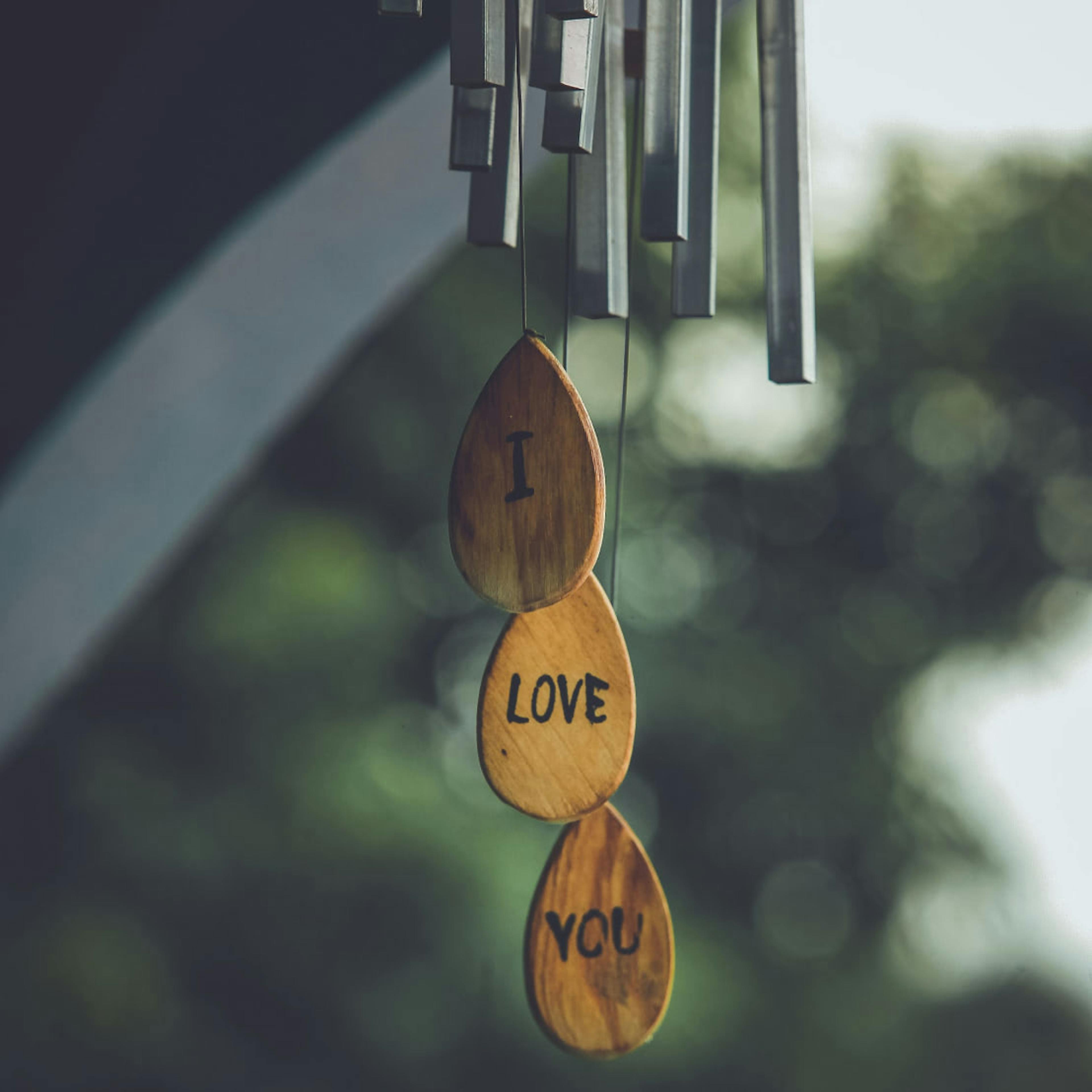 A wind chime gifted between friends that has the words "I love you" written on it.