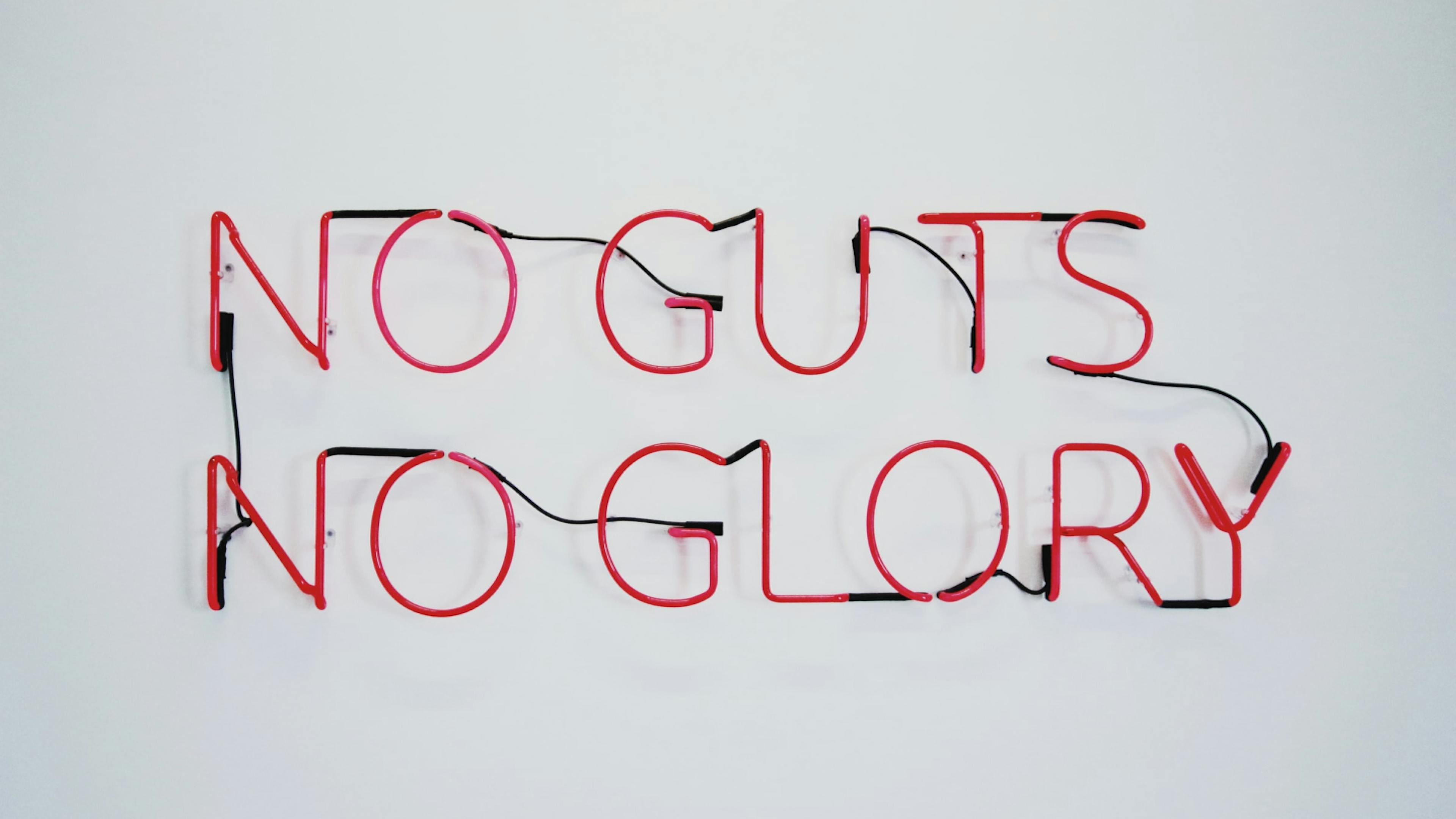 A sign reading "no guts no glory" referring to the larger gut of an aging man.