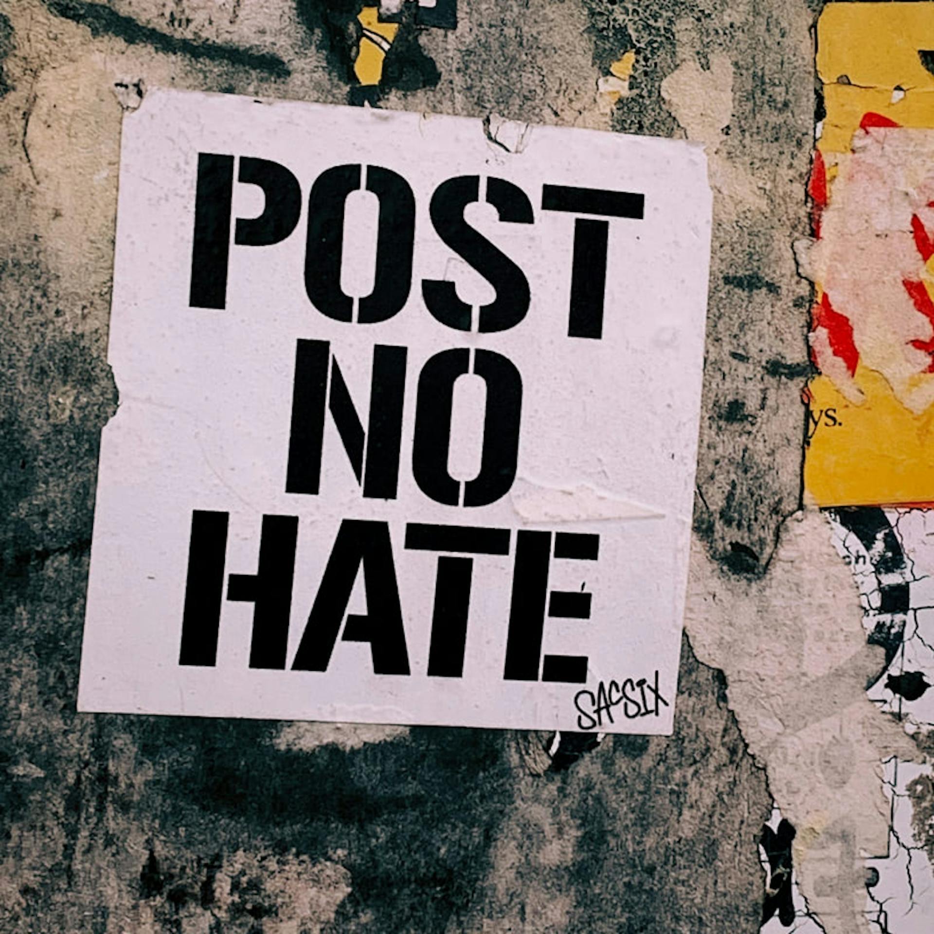 A sign reads "post no hate"