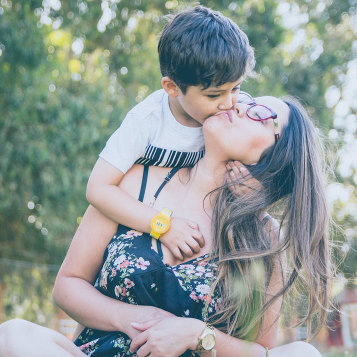 Mother kissing son