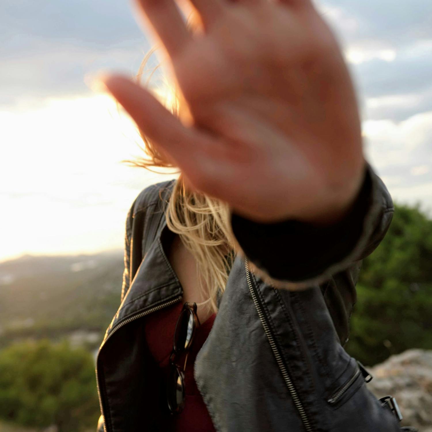 Woman holding palm in front of camera