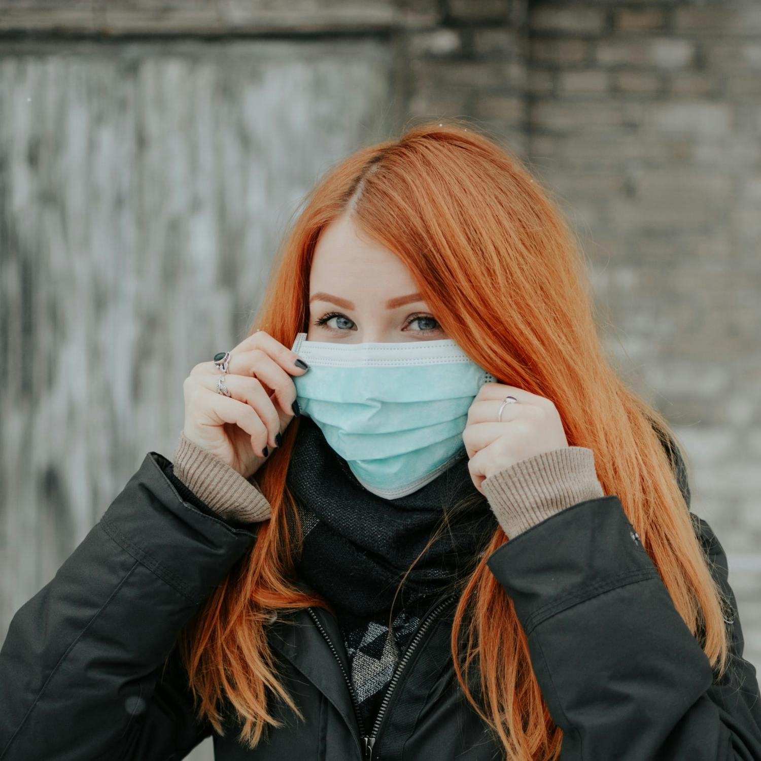 A woman wears a protective mask