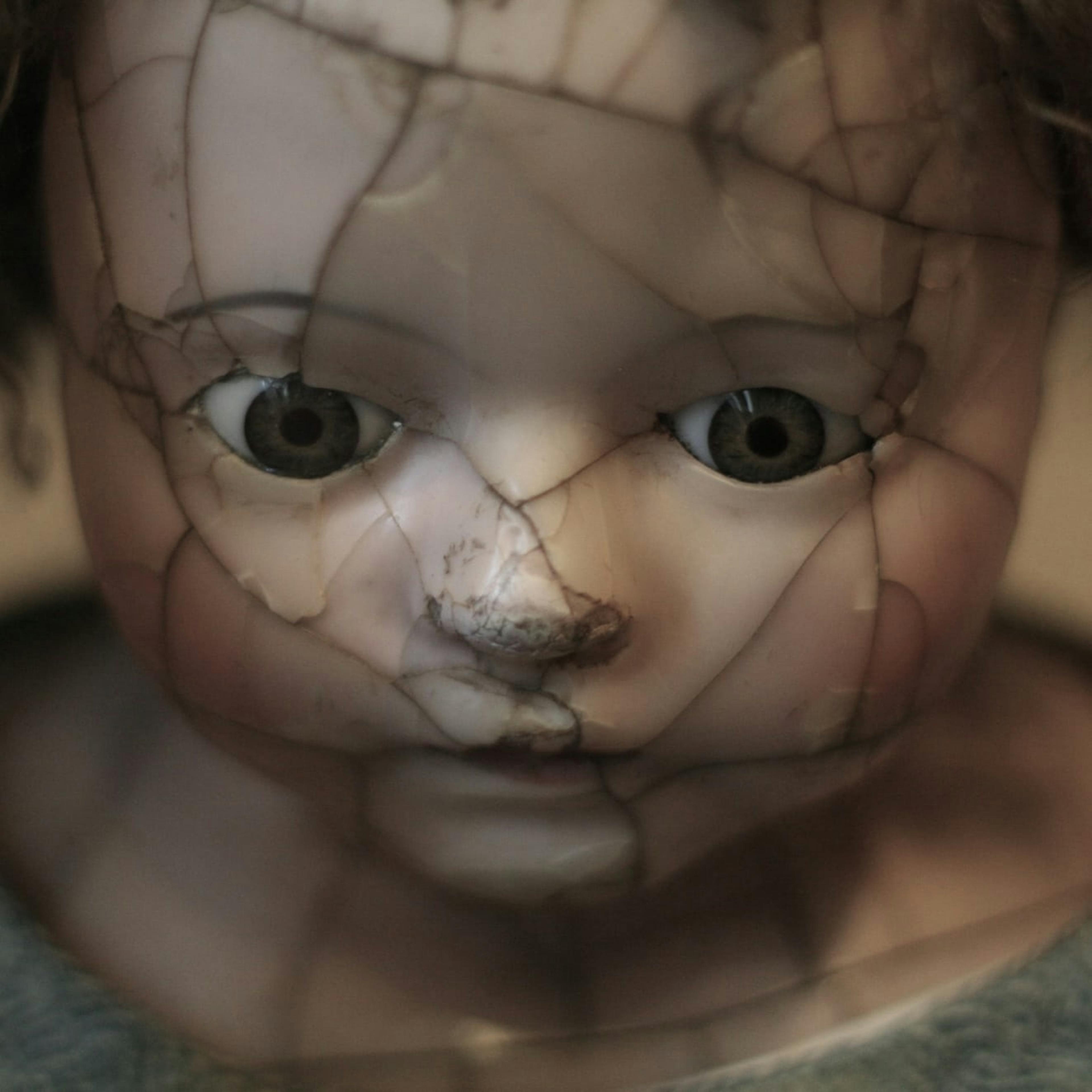 A cracked porcelain doll from a Romanian orphanage.