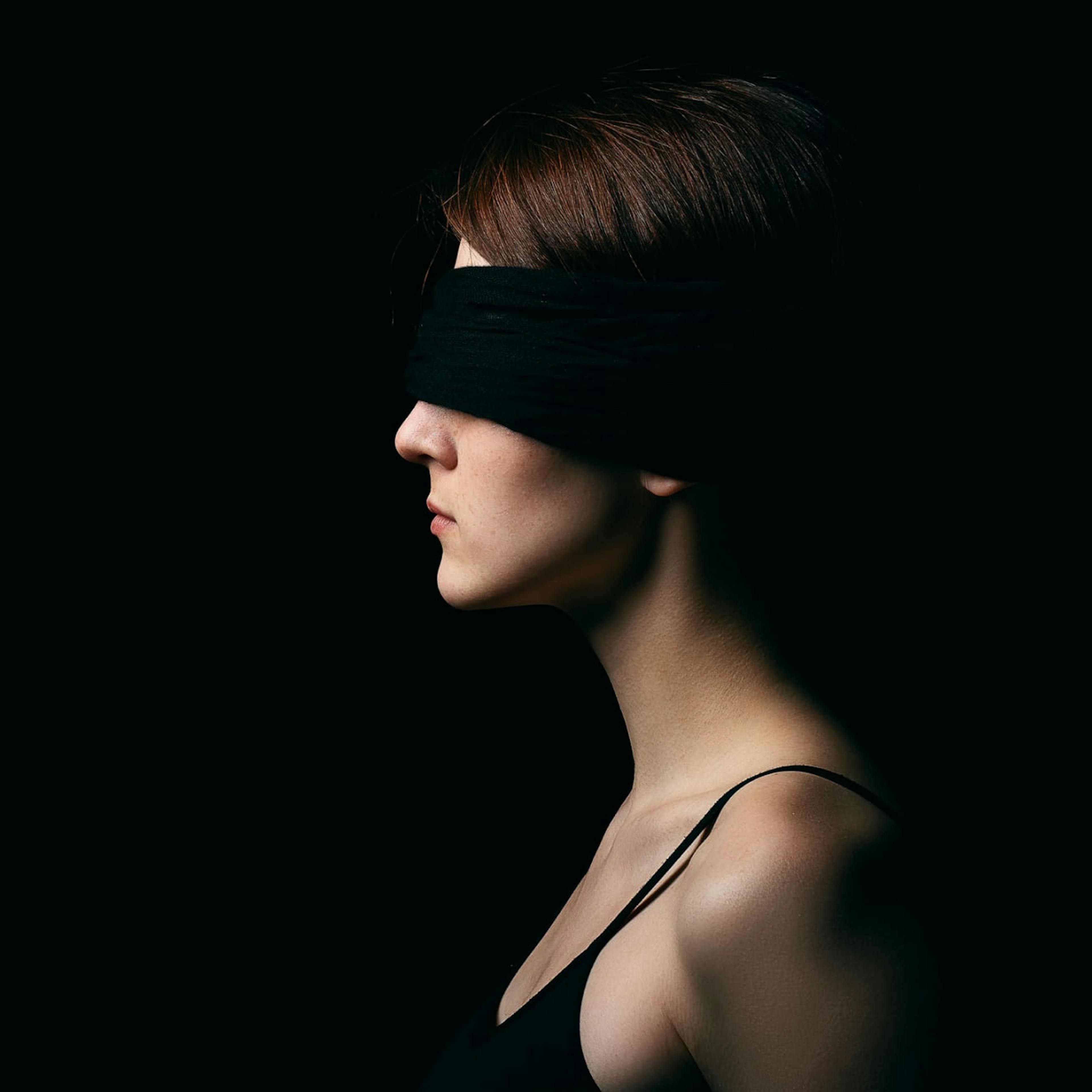 A woman is blindfolded before her illegal abortion.