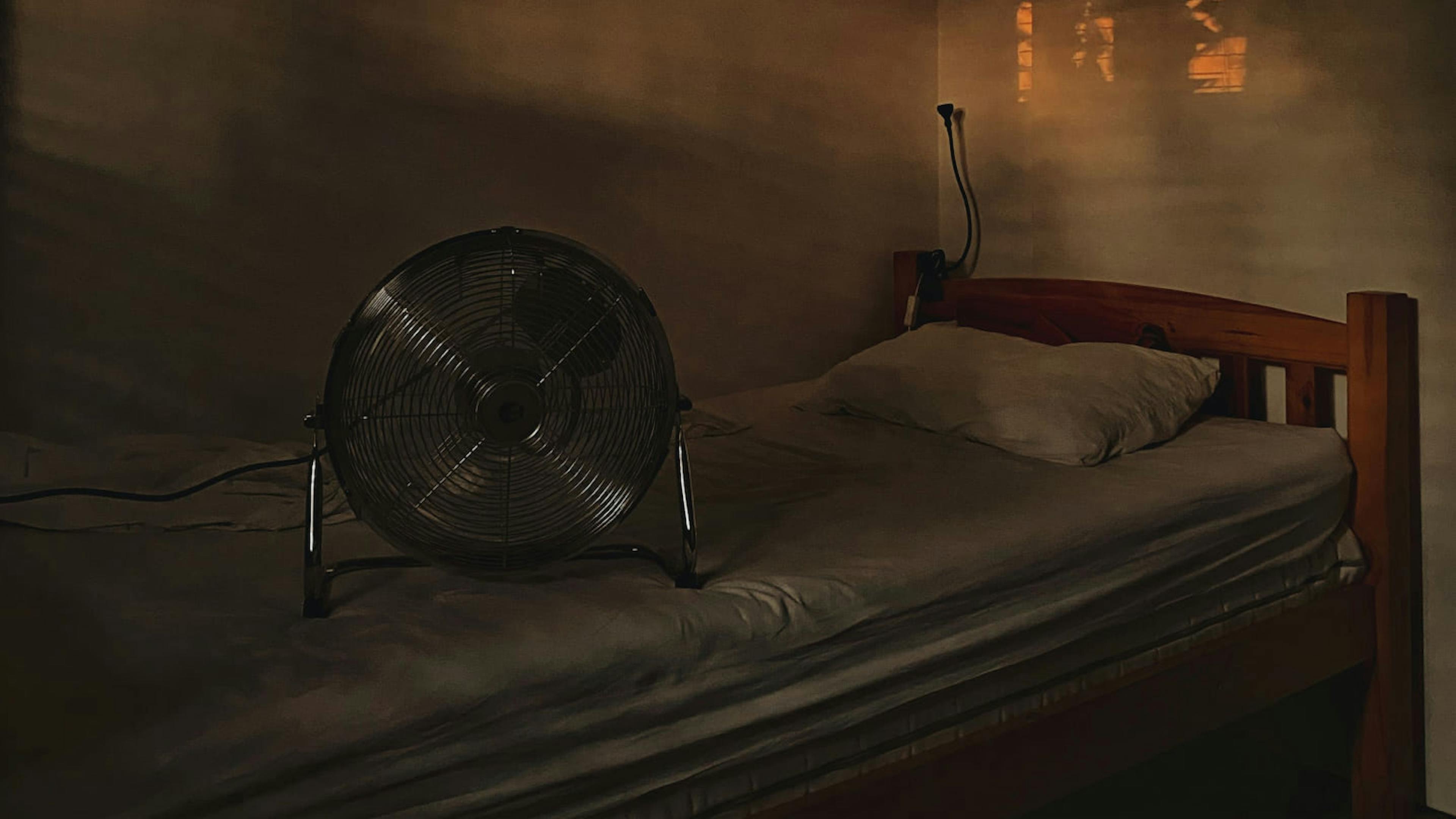 A bed and a fan are all that occupy a small bedroom in Manila.