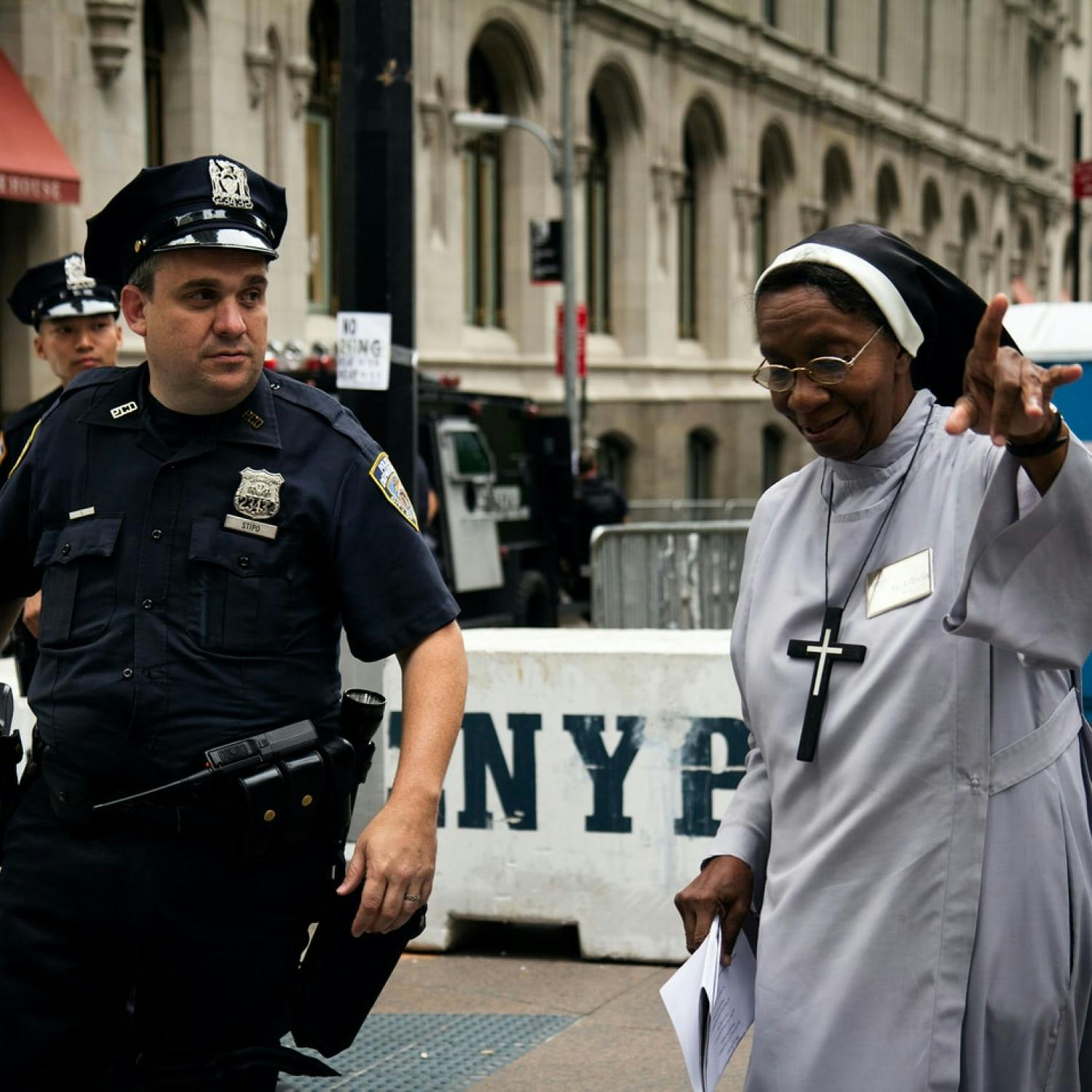 A black nun talks to a white police officer