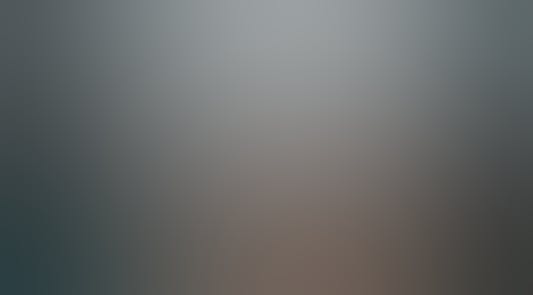 Silhouette of person running down a wet road.