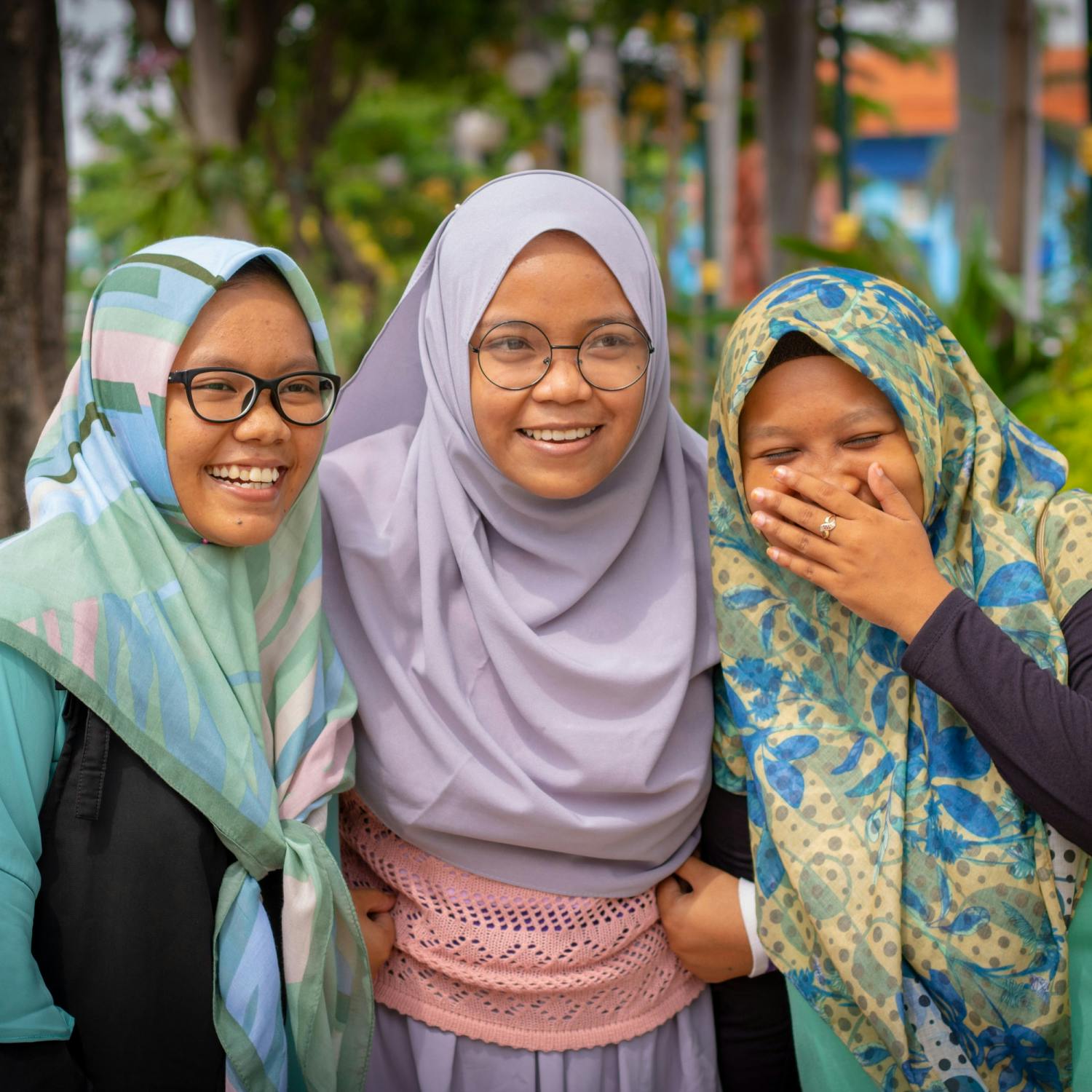 Three Muslim women laughing