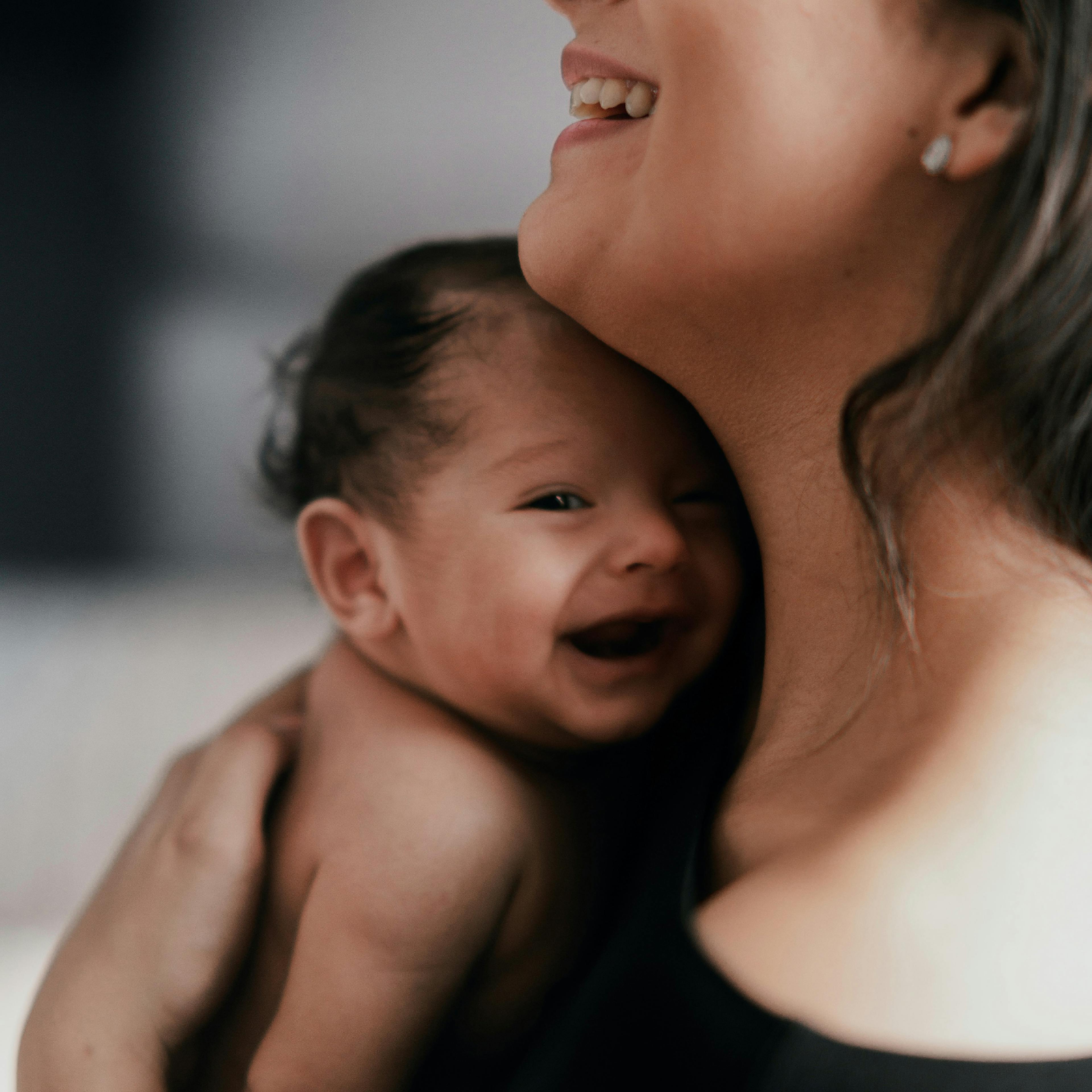 Woman and her baby laughing