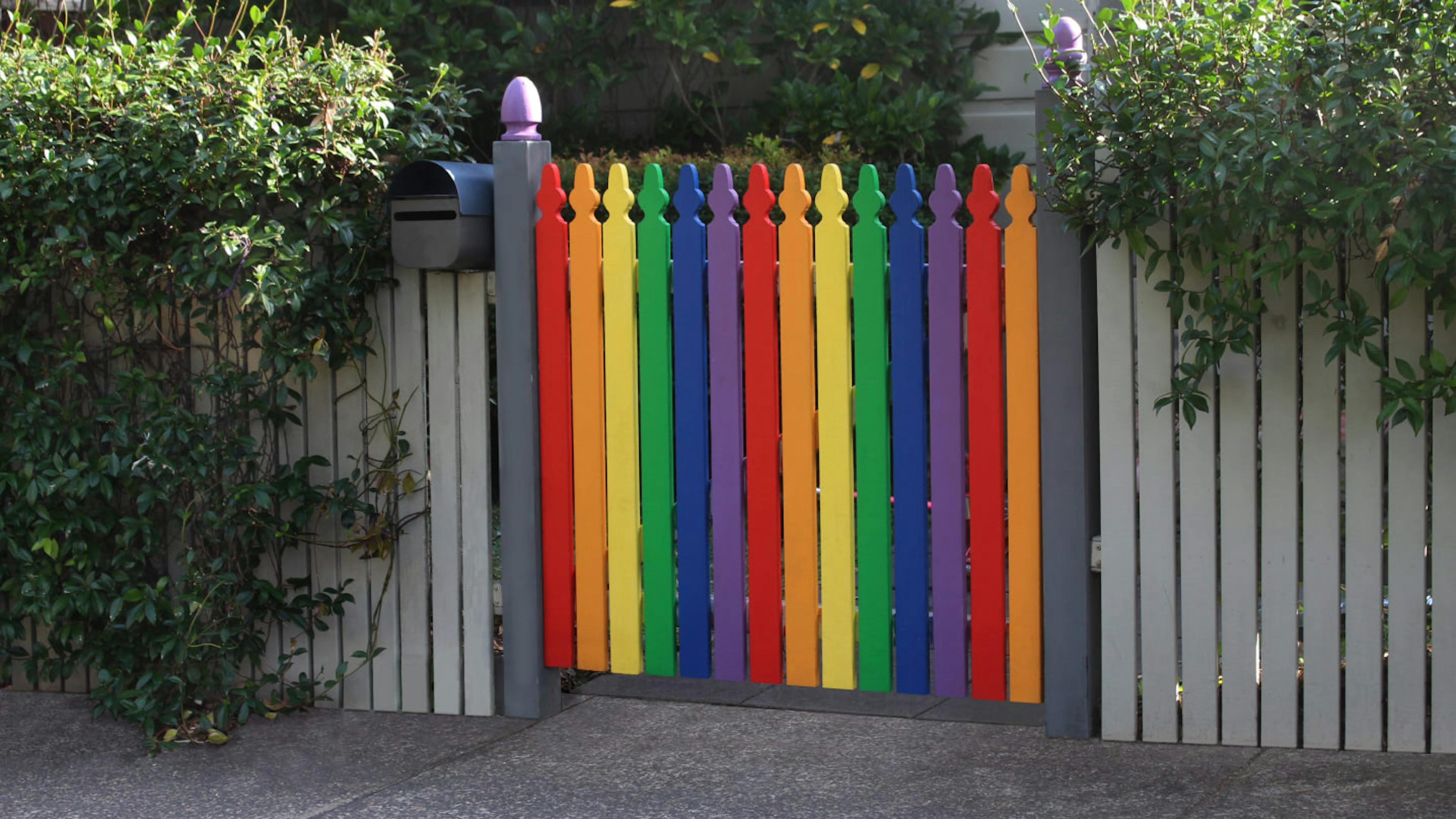 A rainbow picket fence illustrates that you can have your dream life and be queer.
