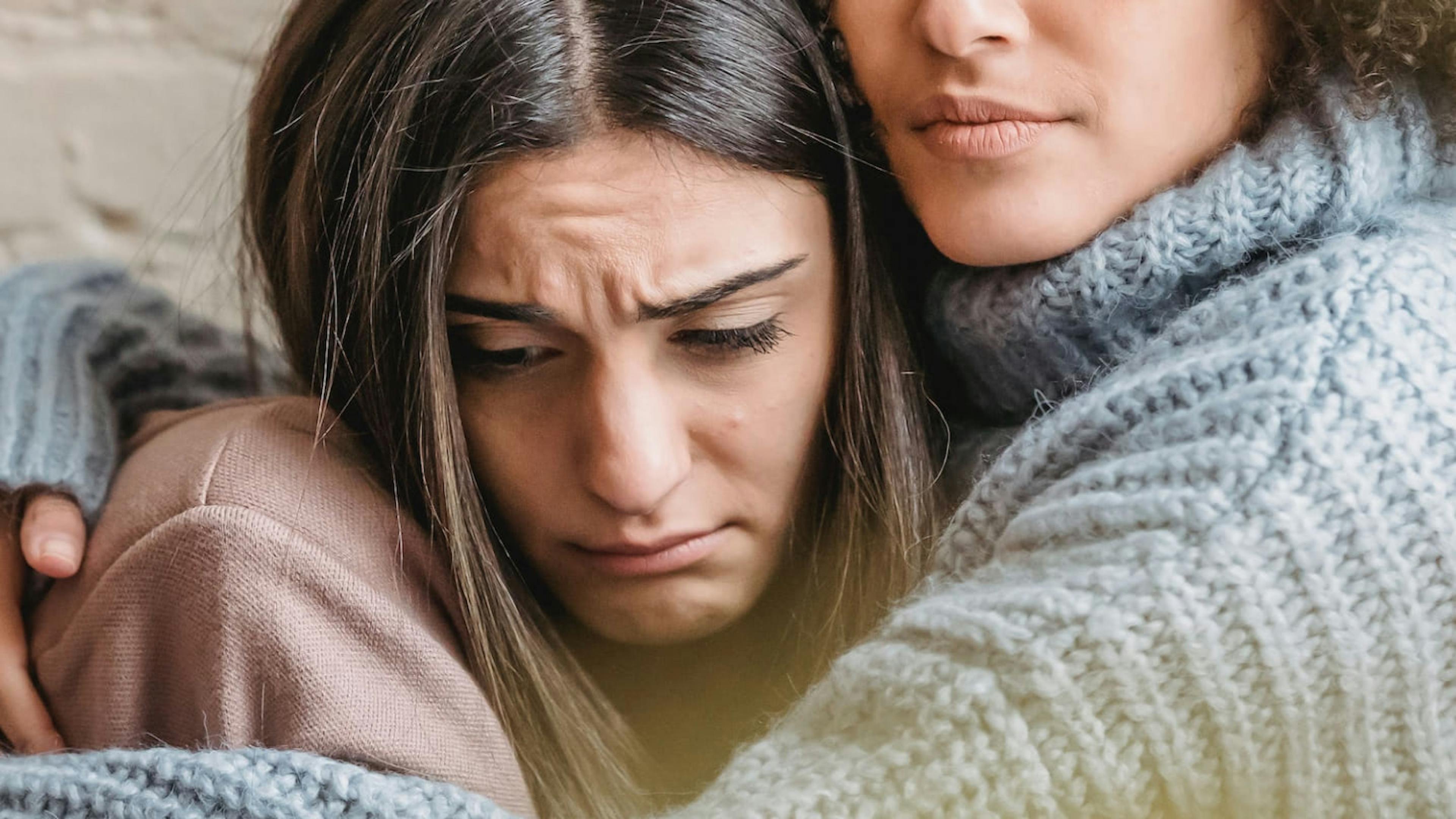 A woman on the brink of divorce is comforted by a friend.
