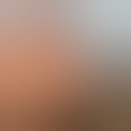 A woman holding her hand up, obscuring part of her face.