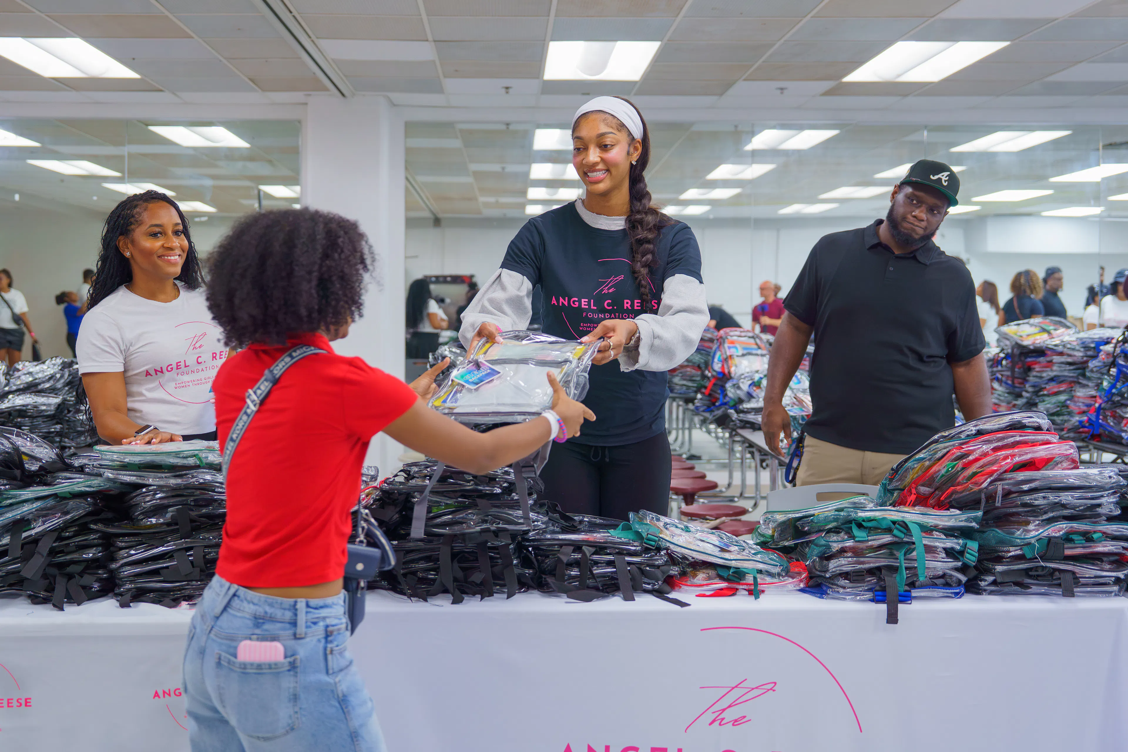 Angel Reese Passing out book bags