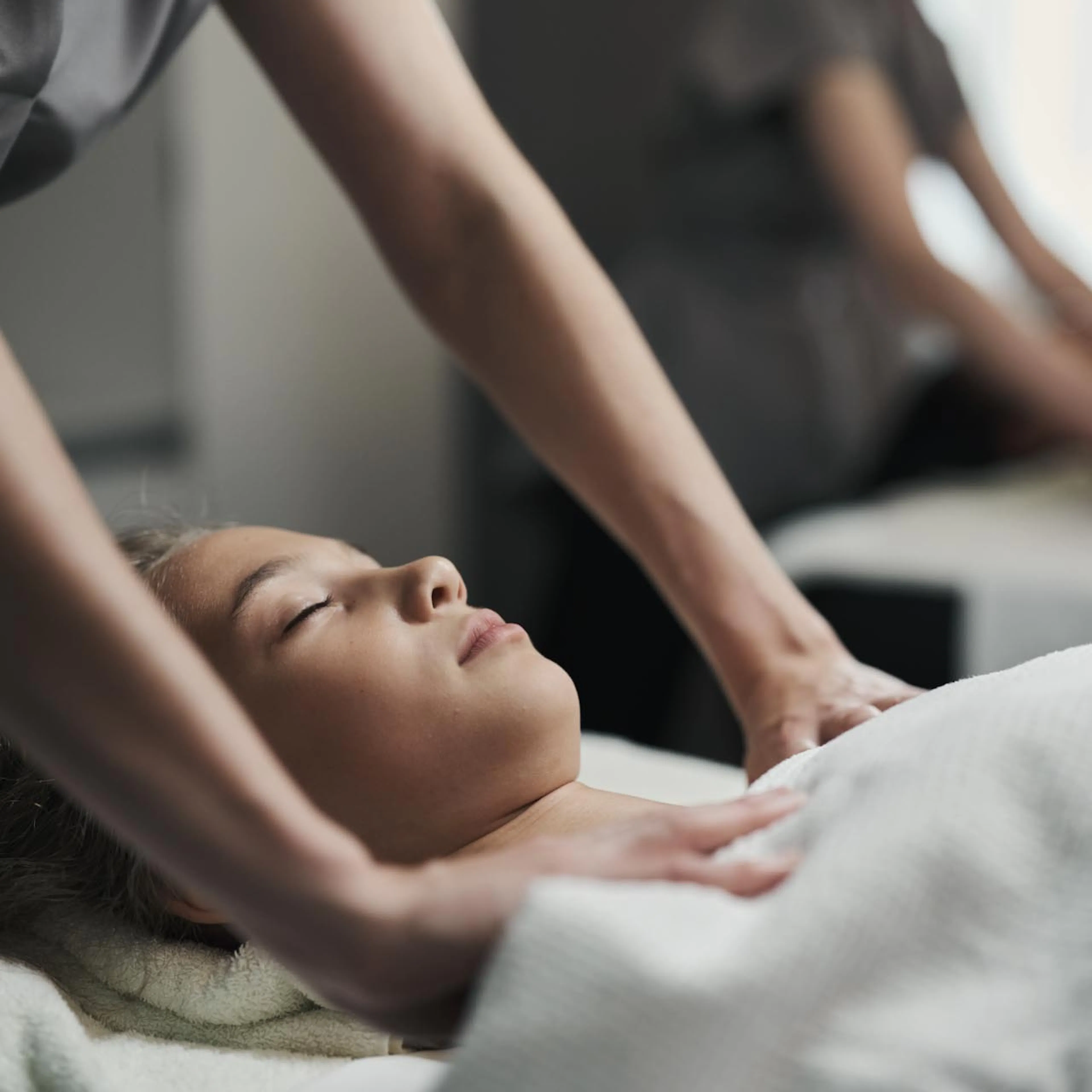 Frau bekommt eine Massage im Behandlungsraum des Alpenrose Familux Resorts.