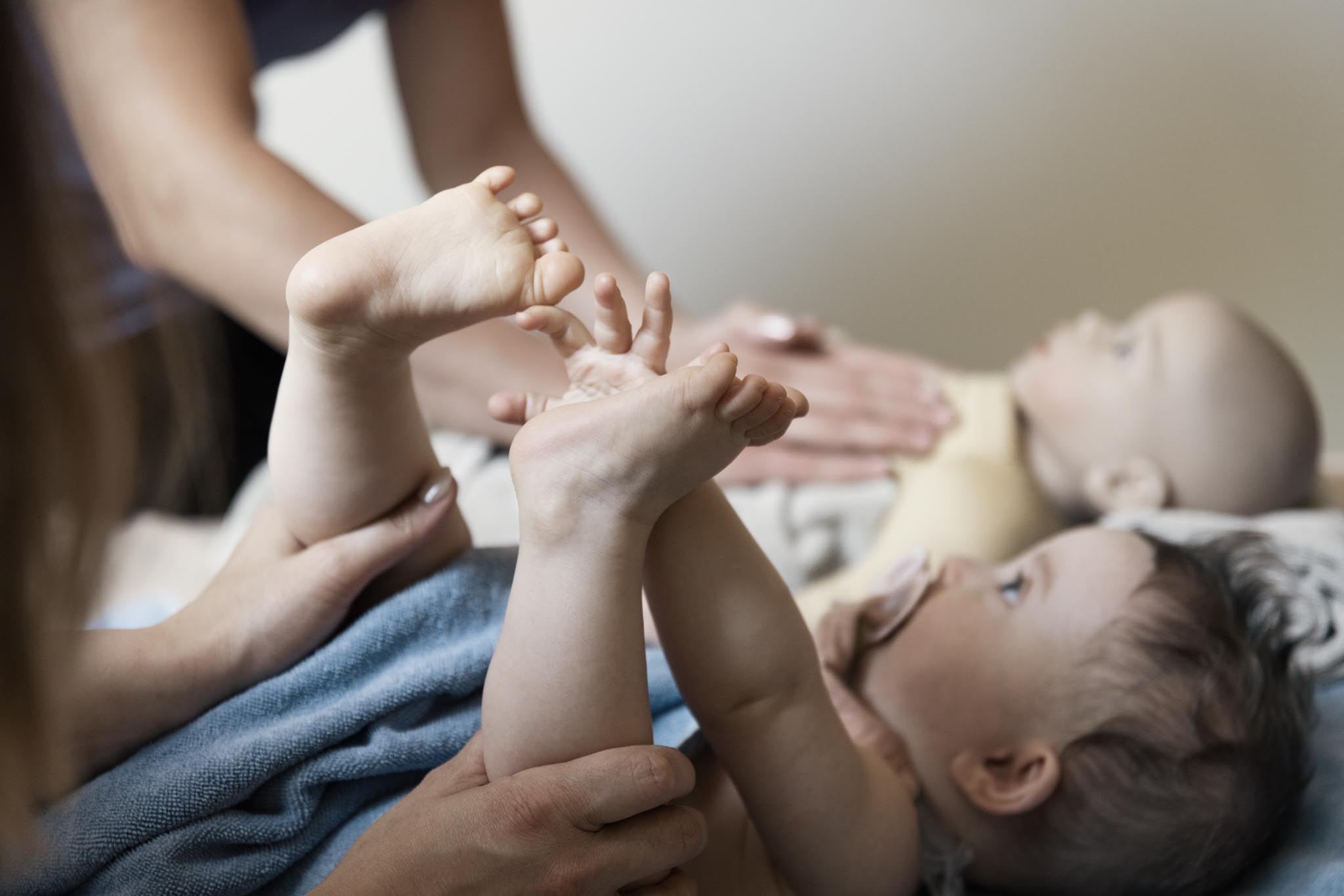 Baby massage in a treatment room at a Familux Resort.