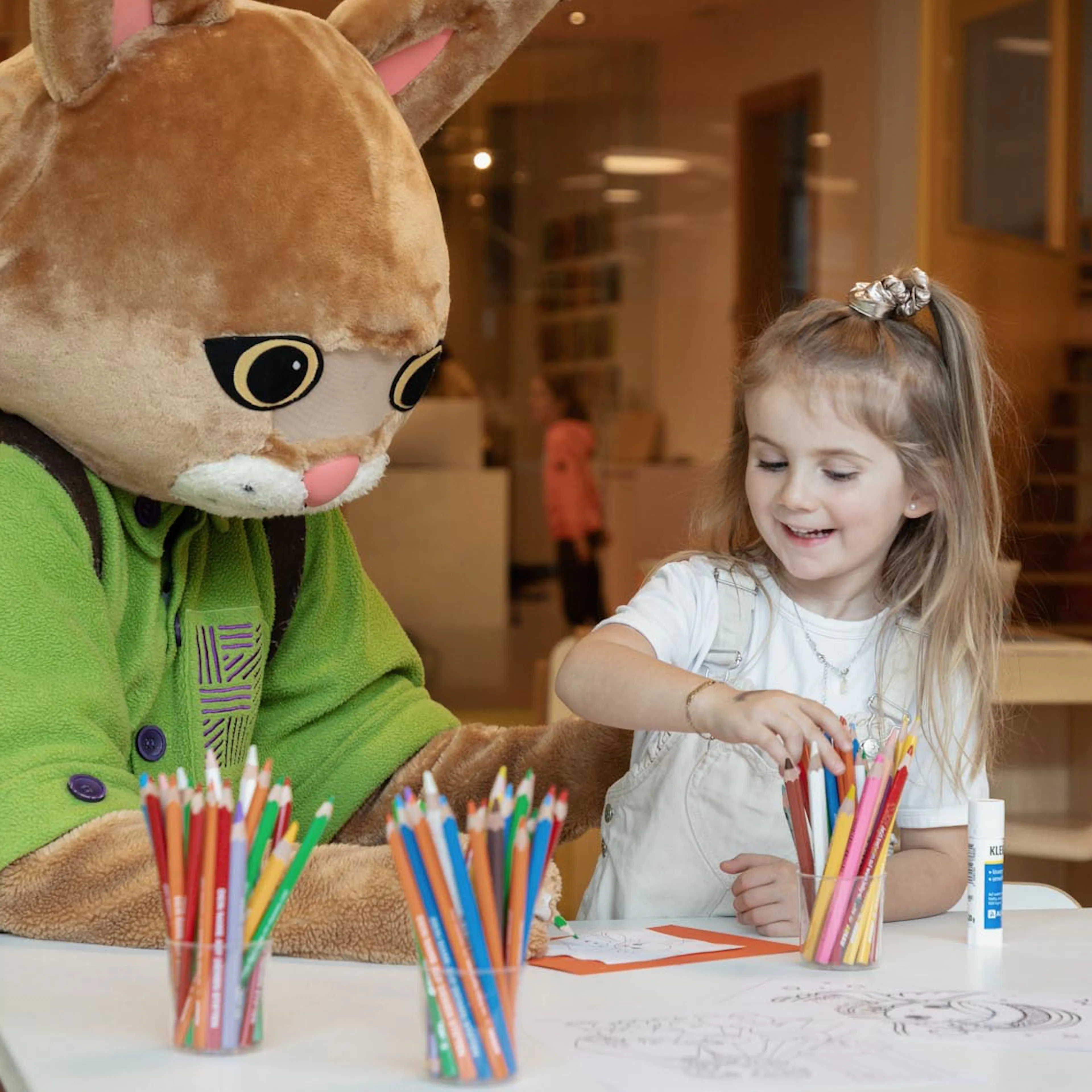 Girl doing crafts in the Kids Club of a Familux Resort with Lila Lux.