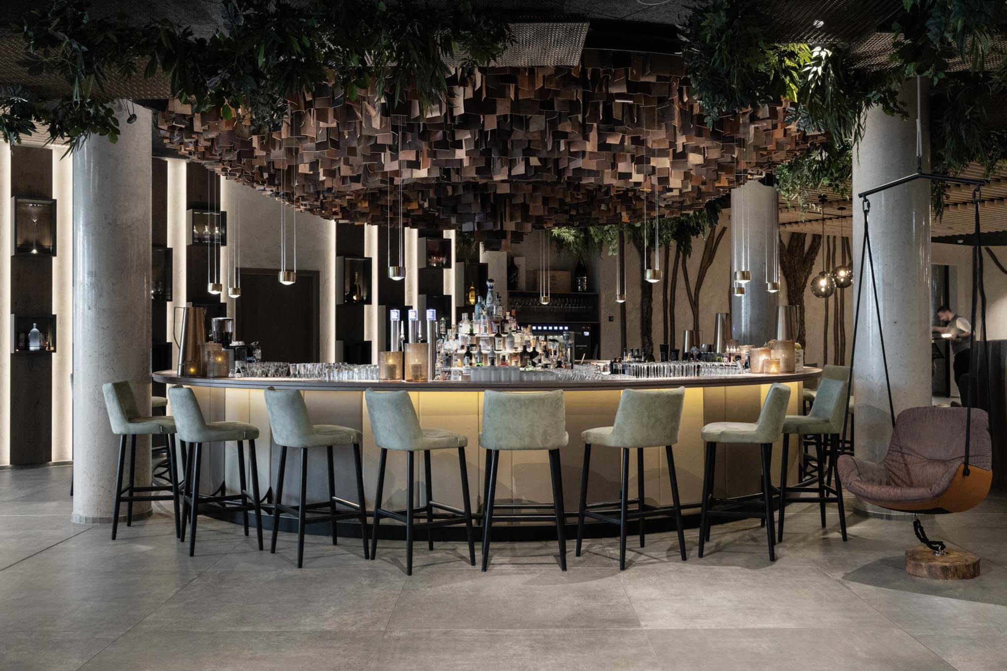 Hotel bar with chairs at The Grand Green – Familux Resort.
