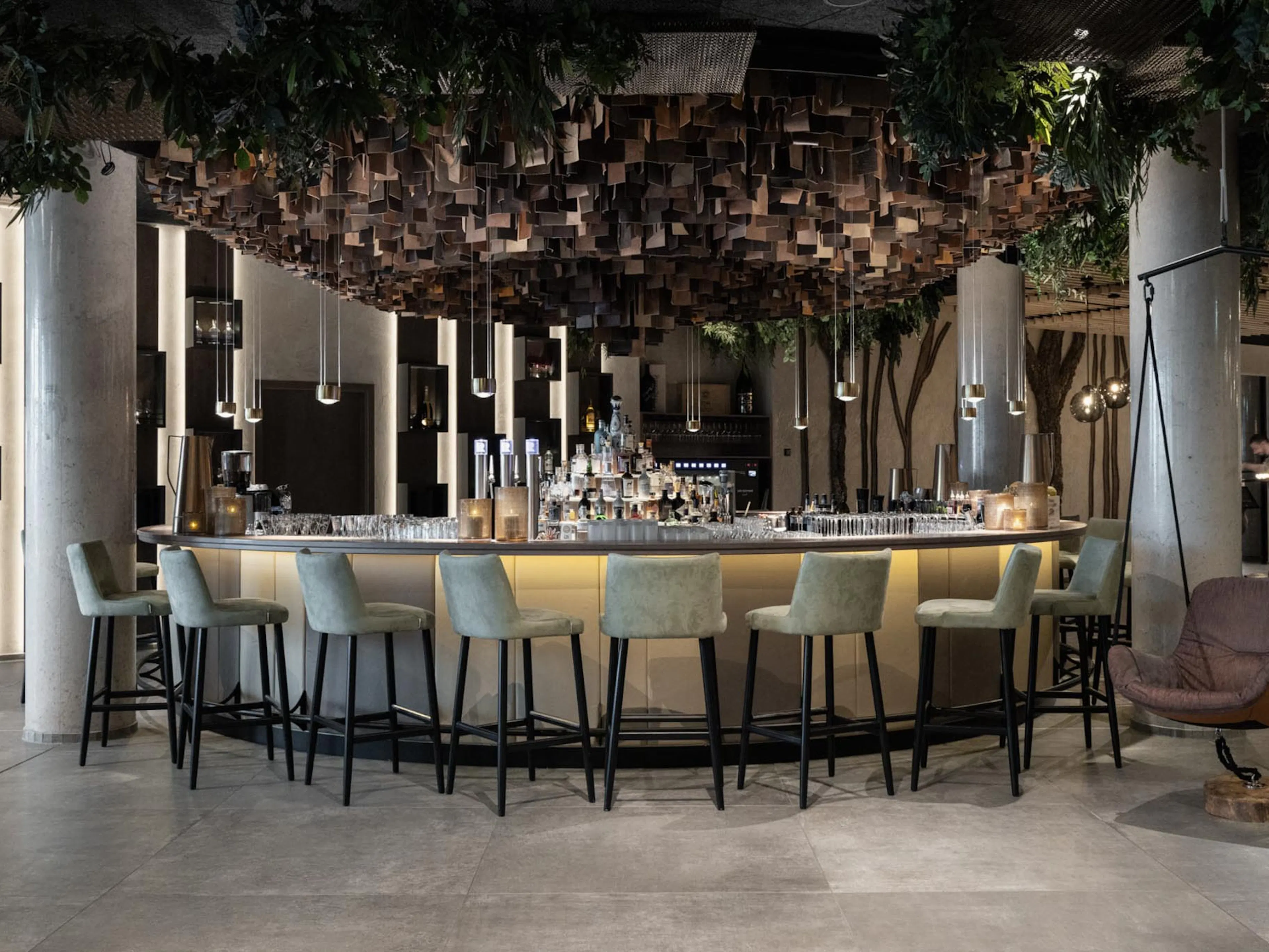 Hotel bar with chairs at The Grand Green – Familux Resort.