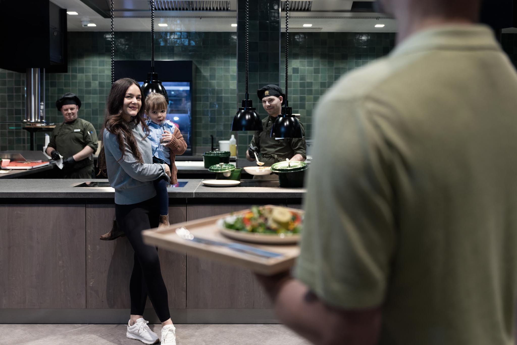 Family standing at the buffet with the chefs of The Grand Green – Familux Resort.