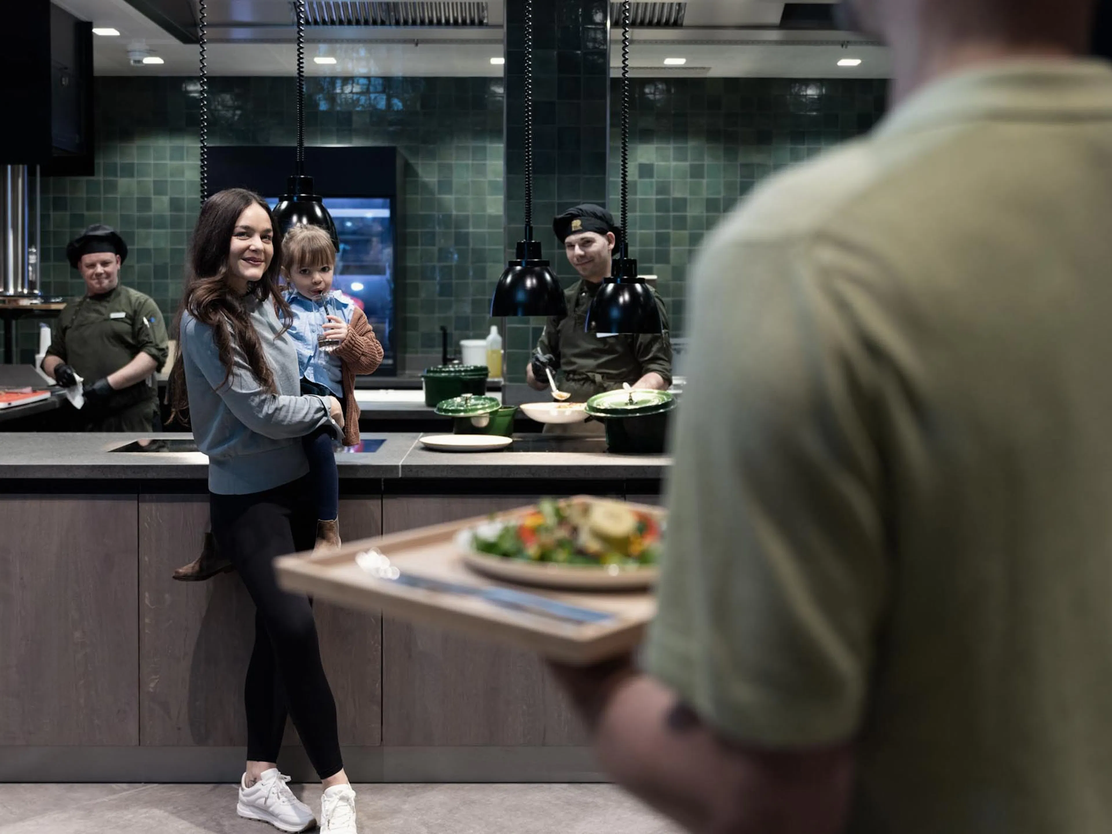Family standing at the buffet with the chefs of The Grand Green – Familux Resort.